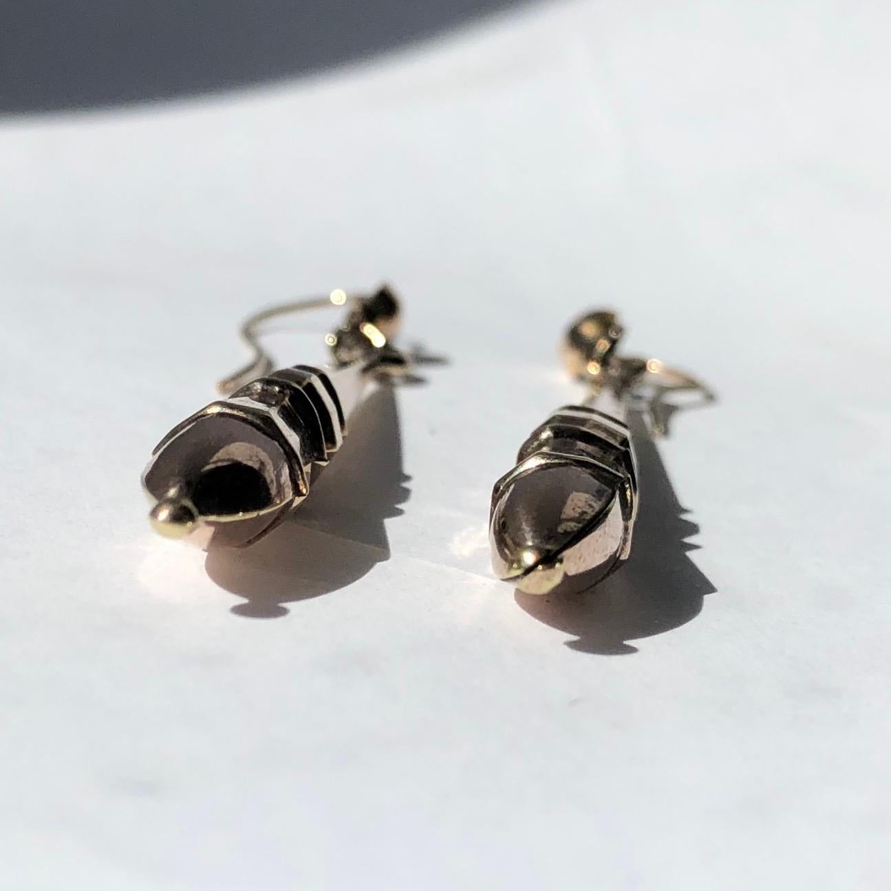 A pair of stunning Victorian torpedo earrings. Each is earring has geo shaped detail moulded in the 9ct gold. 

Torpedo Length: 43mm
Drop From Ear: 58mm

Weight: 3.05g