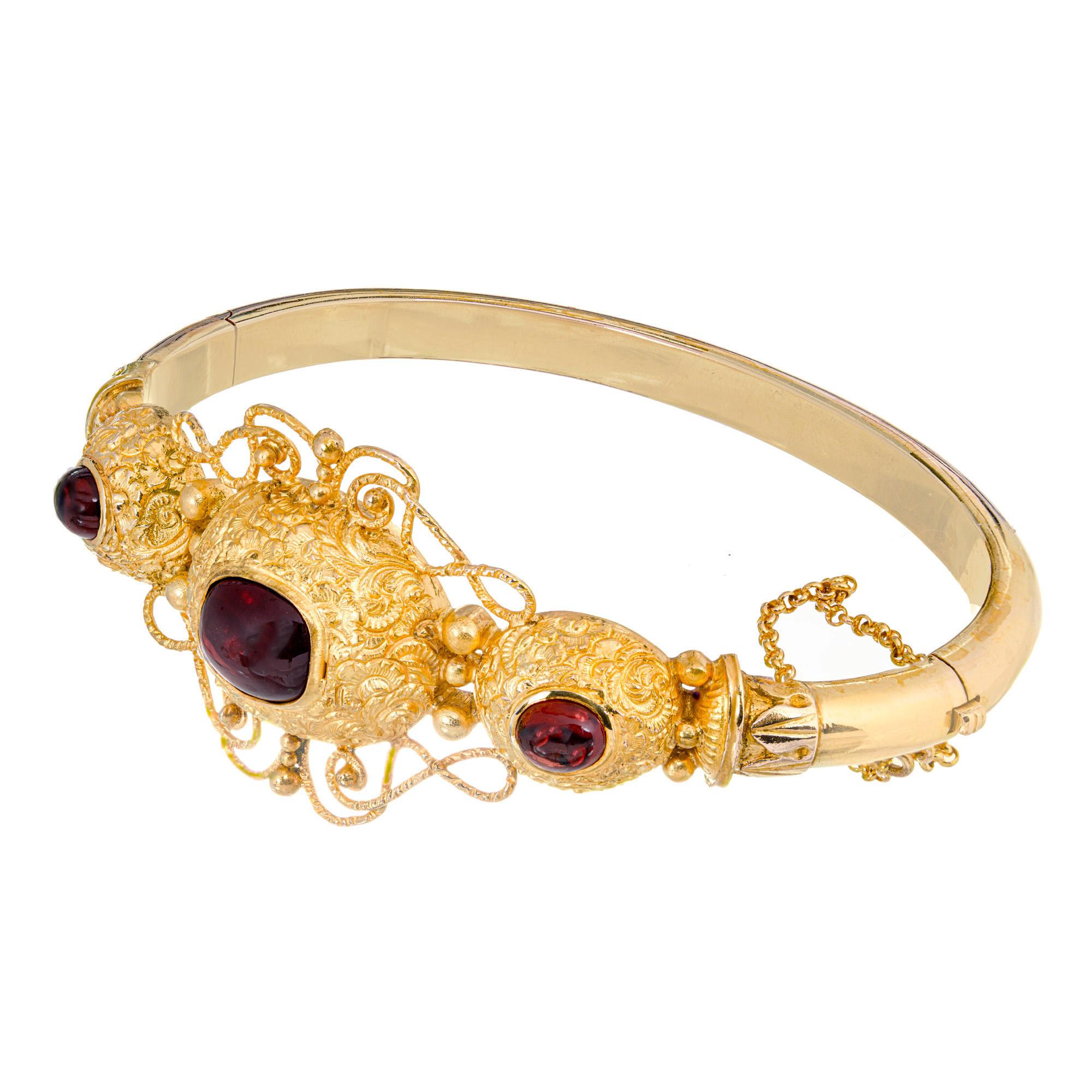 Unique Victorian 1850's wonderful bangle bracelet. Set with 3 oval cabochon garnets set in a 14k yellow gold setting. Handmade, beautifully crafted with natural patina. There is also a Safety chain added later. Fits up to  7.5 inch wrist. 

1