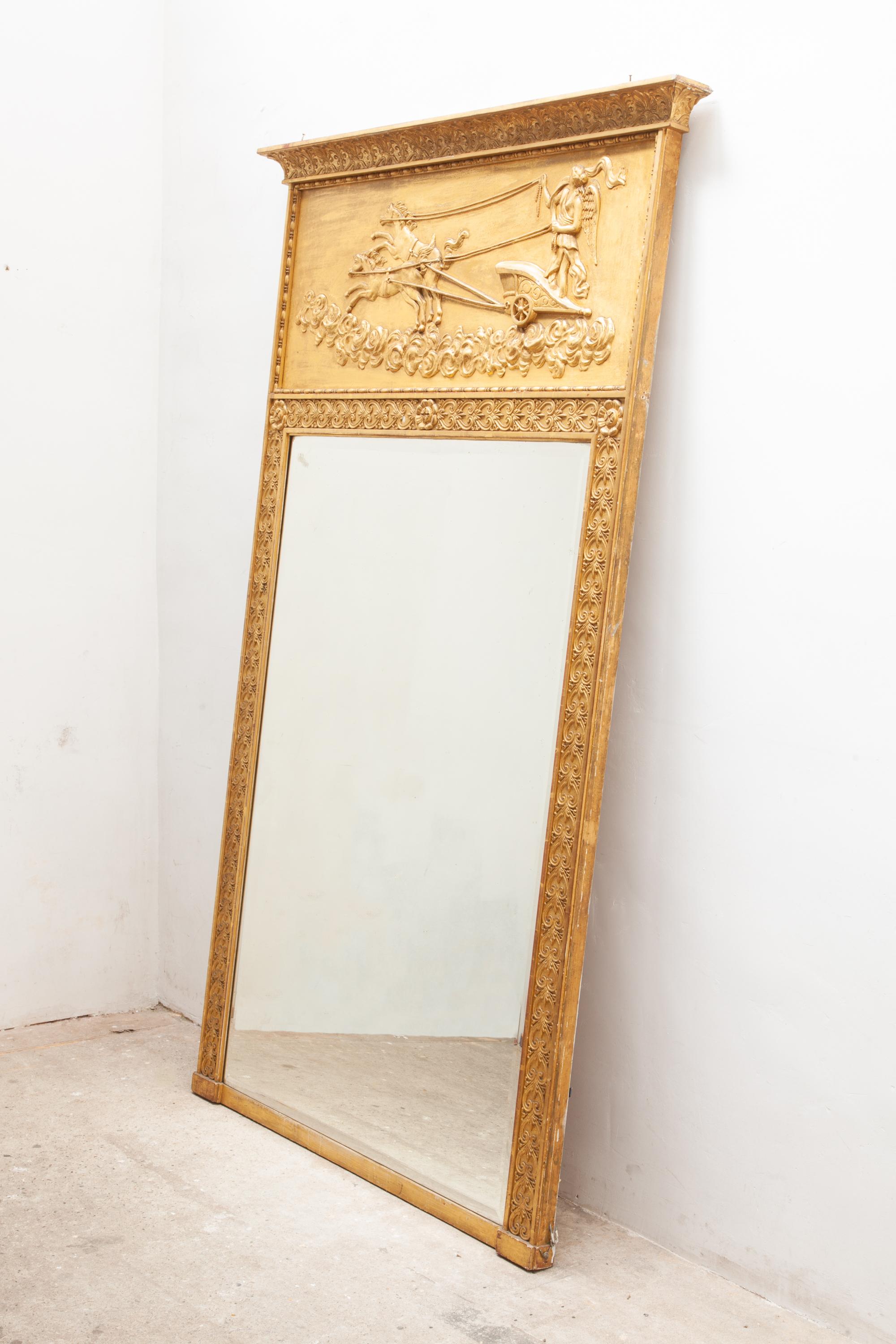 Victorian giltwood overmantel mirror with a frieze with applied classical decoration the godess Eos and her horses bringing the day and sunshine,having original bevelled edge mirror in finely carved ornament gilt frame,circa 1870.

This elegantly