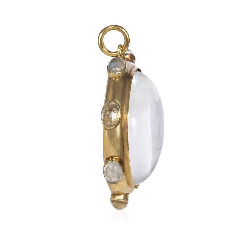 An antique oversized gold and carved crystal locket pendant with a crystal lozenge surround, in 18k.

Dimensions: approximately 2.25