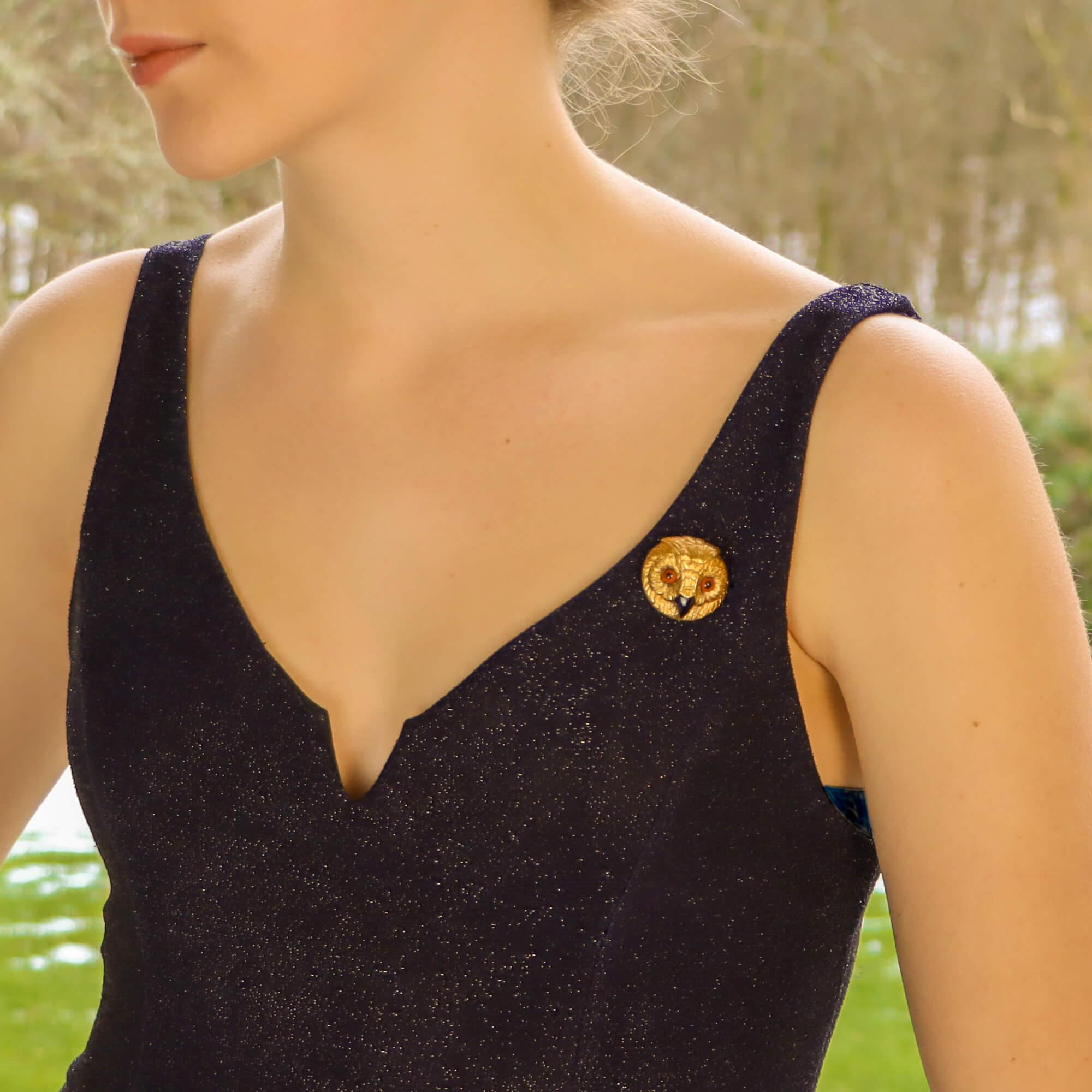 A beautifully hand crafted Victorian owl's head brooch set in 9k yellow gold. 

The brooch features fine feathered detailing, particularly around the eyes which are small glass beads and a striking black onyx beak. The piece is secured to the