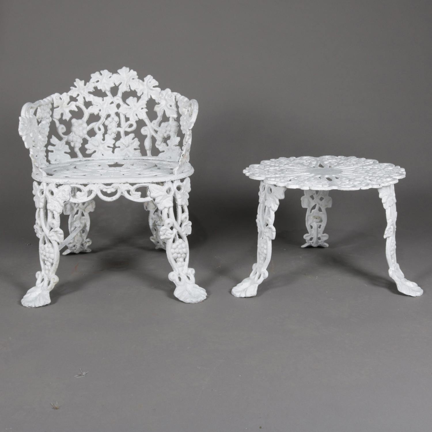 A 2 piece set includes a Victorian reticulated garden bench featuring cast iron construction in grape and leaf pattern and seated on cabriole legs terminating in stylized paw feet with matching garden table, painted white, 20th century

Measures: