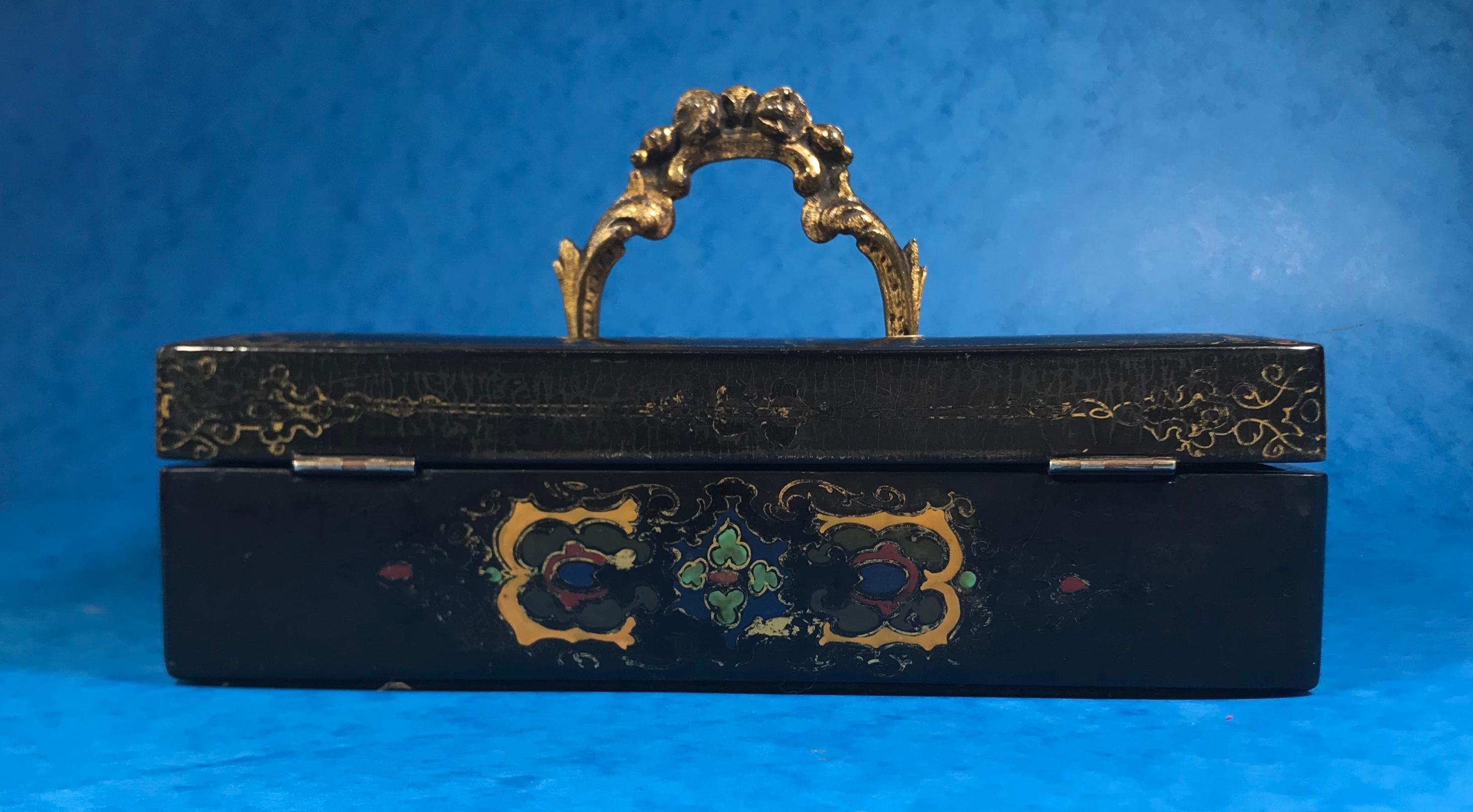 Victorian painted papier mâché inkstand.
A beautiful ladies papier mâché inkstand daring with inlaid birds and leaves to the top of the box in mother of peal, there are wonderful decorative pattens in gilt, yellow, green and red to the front and