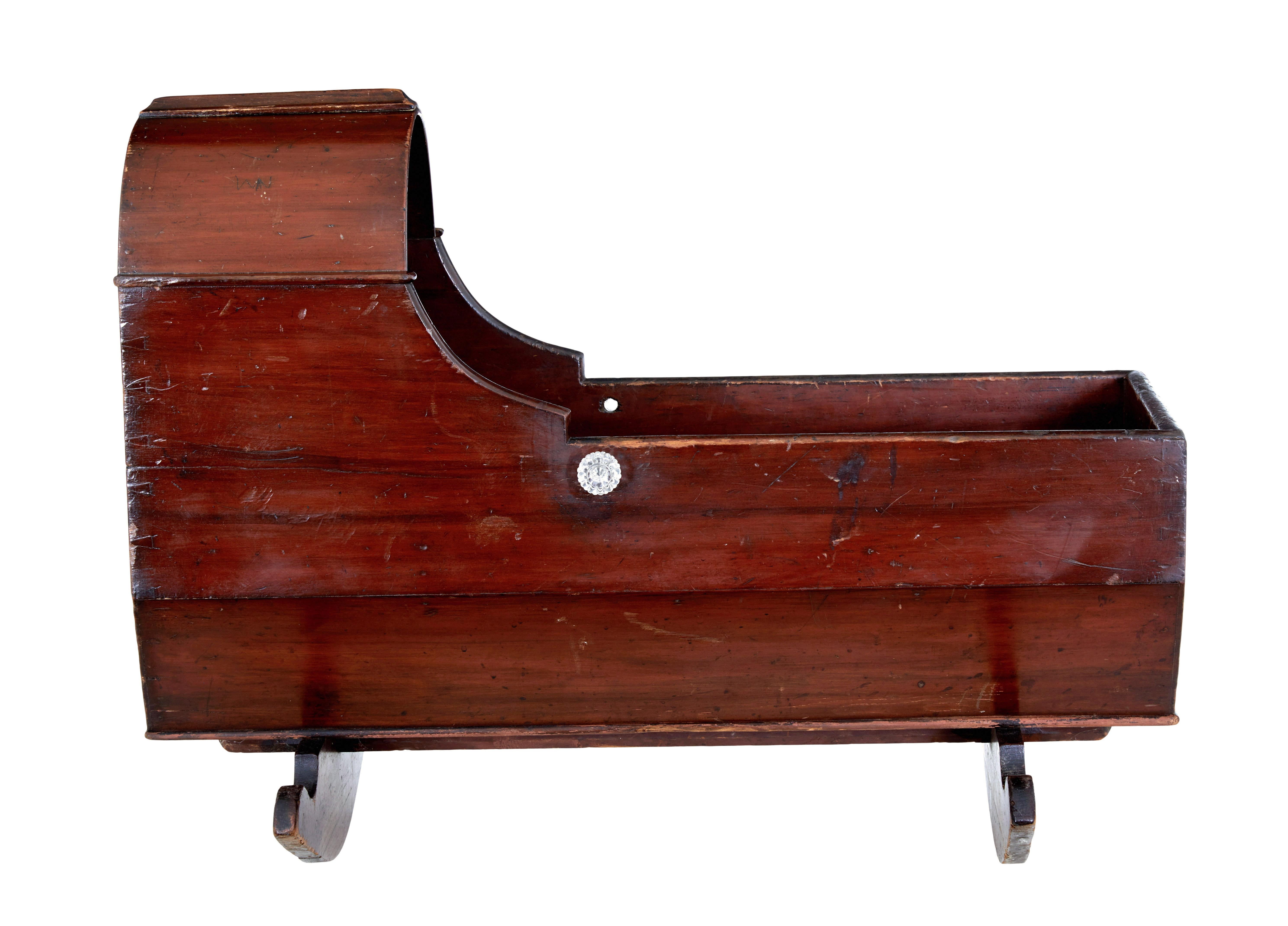 Victorian painted pine canopy top cradle circa 1870.

Good example of how we used to put our children to sleep in the 19th century.

Pine construction with original red wash stain.  Bed space with canopy, placed on 2 sledge rockers.  Decorated with