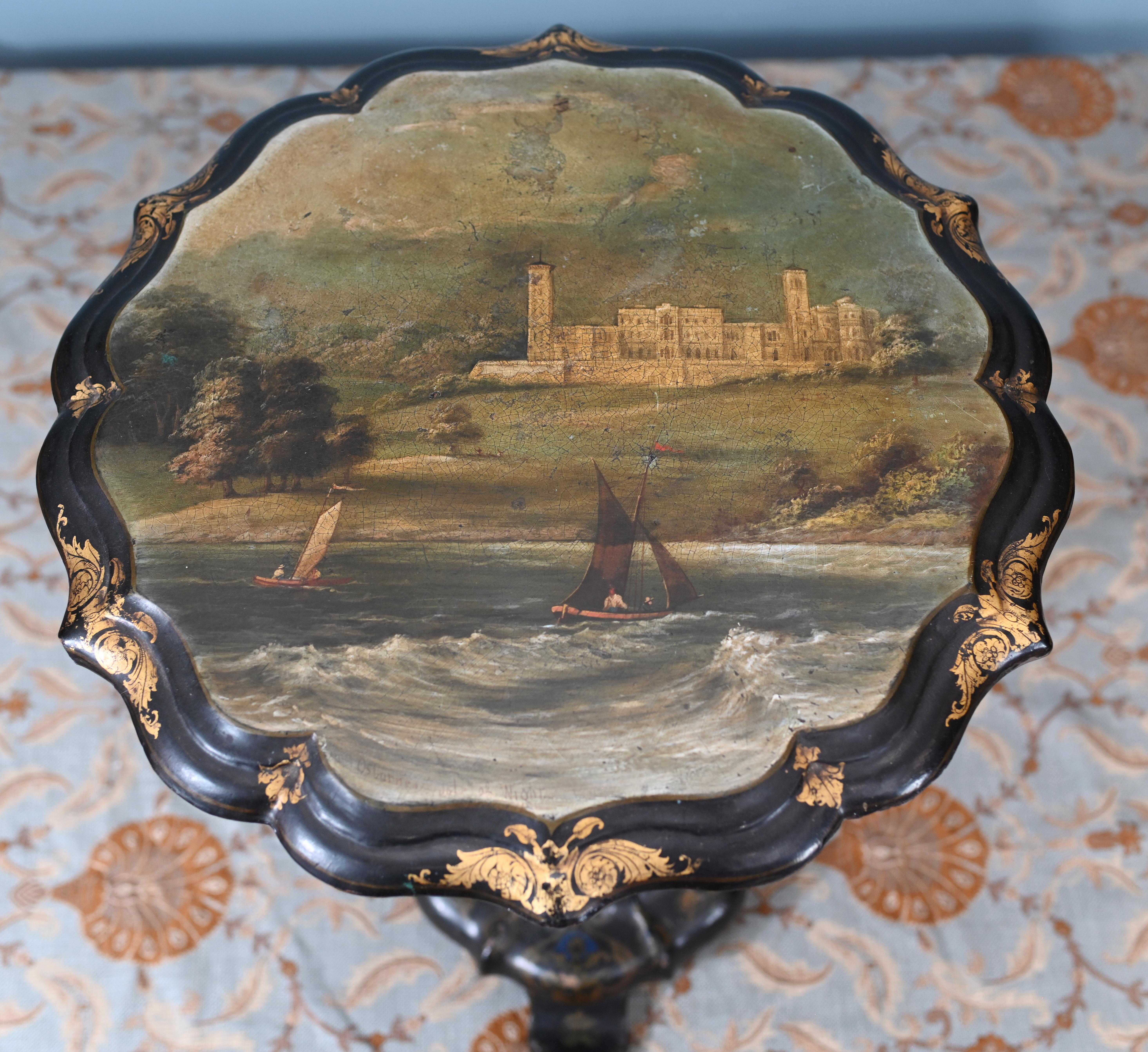 Fine quality Victorian tip table finely decorated with paintings of Queen Victoria's seaside home on the Isle of Wight Osbourne House
Circa 1880 in the style of Jennens and Bettridge Birmingham England
Jennens and Bettridge was a manufacturing