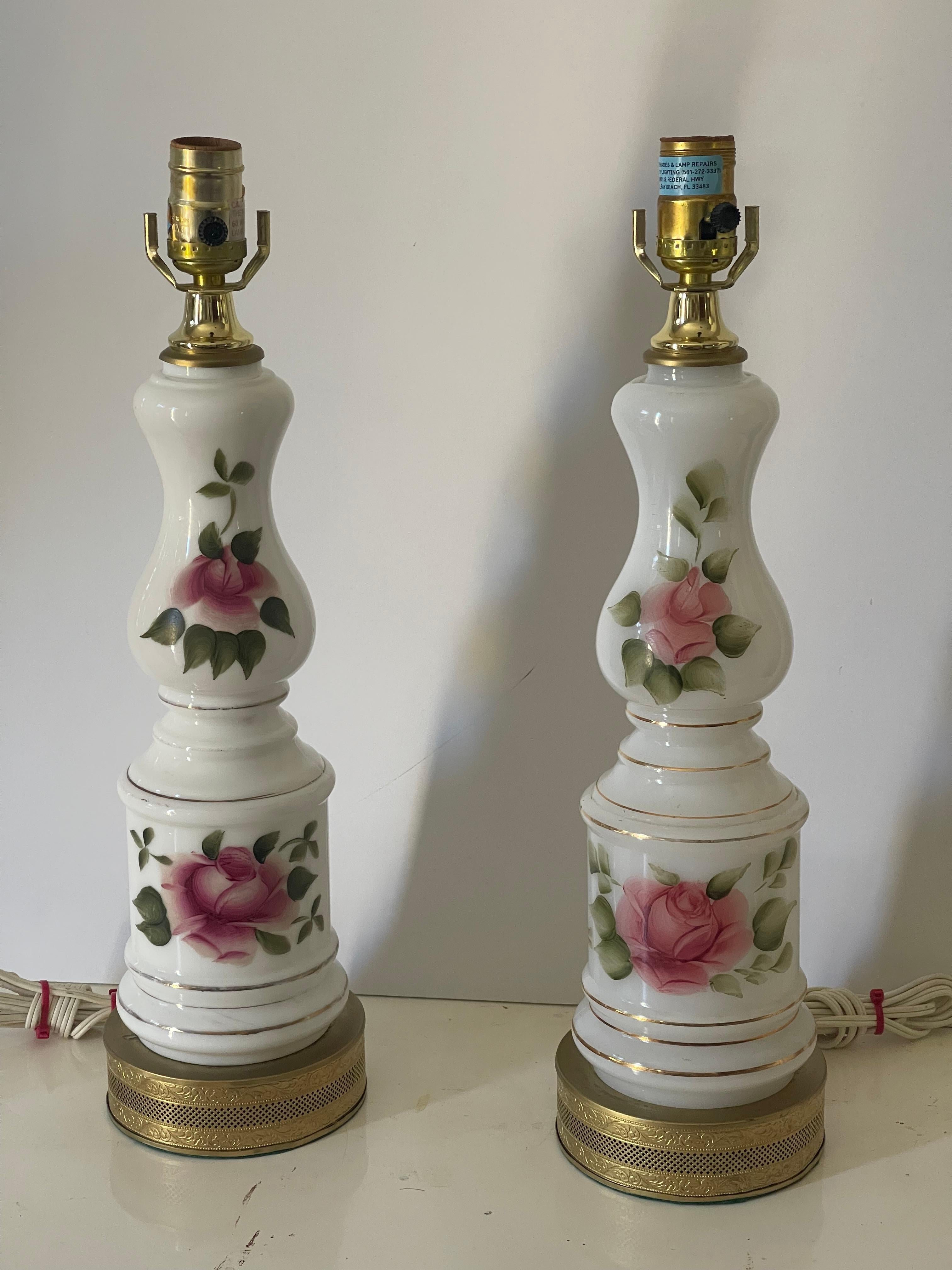 Victorian pair of milk glass lamps on reticulated brass bases hand painted with red roses.Beautiful linen lamp shades with pink and yellow roses trim, Great feminine touch to any interior.