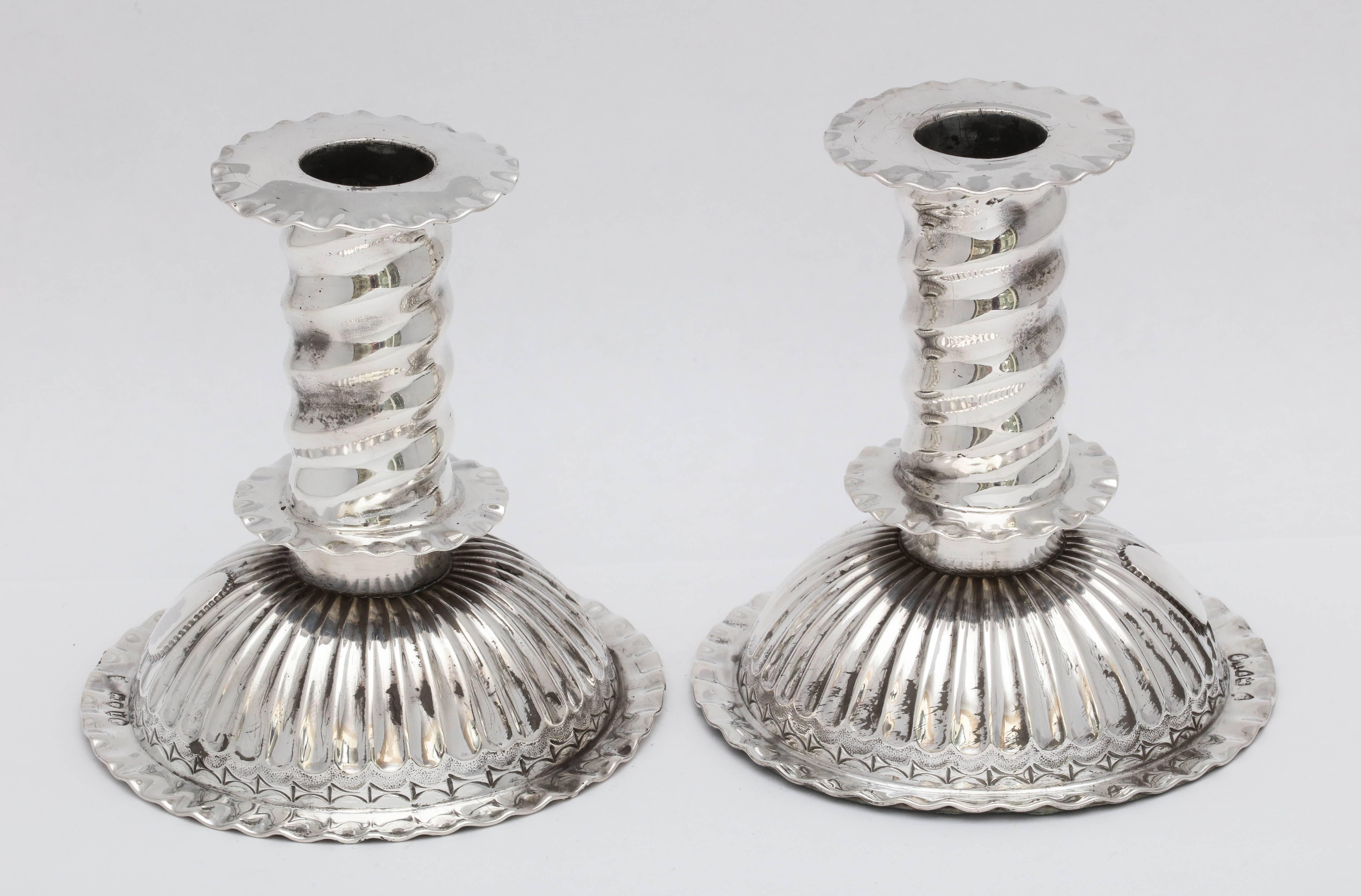 Rare, sterling silver, Victorian pair of Capstan candlesticks in the 16th century European style, London, 1886, Robert Pringle - maker. Removable bobeches. Each measures 4 1/4 inches high x 4 inches diameter across base. Weighted. Vacant cartouche.