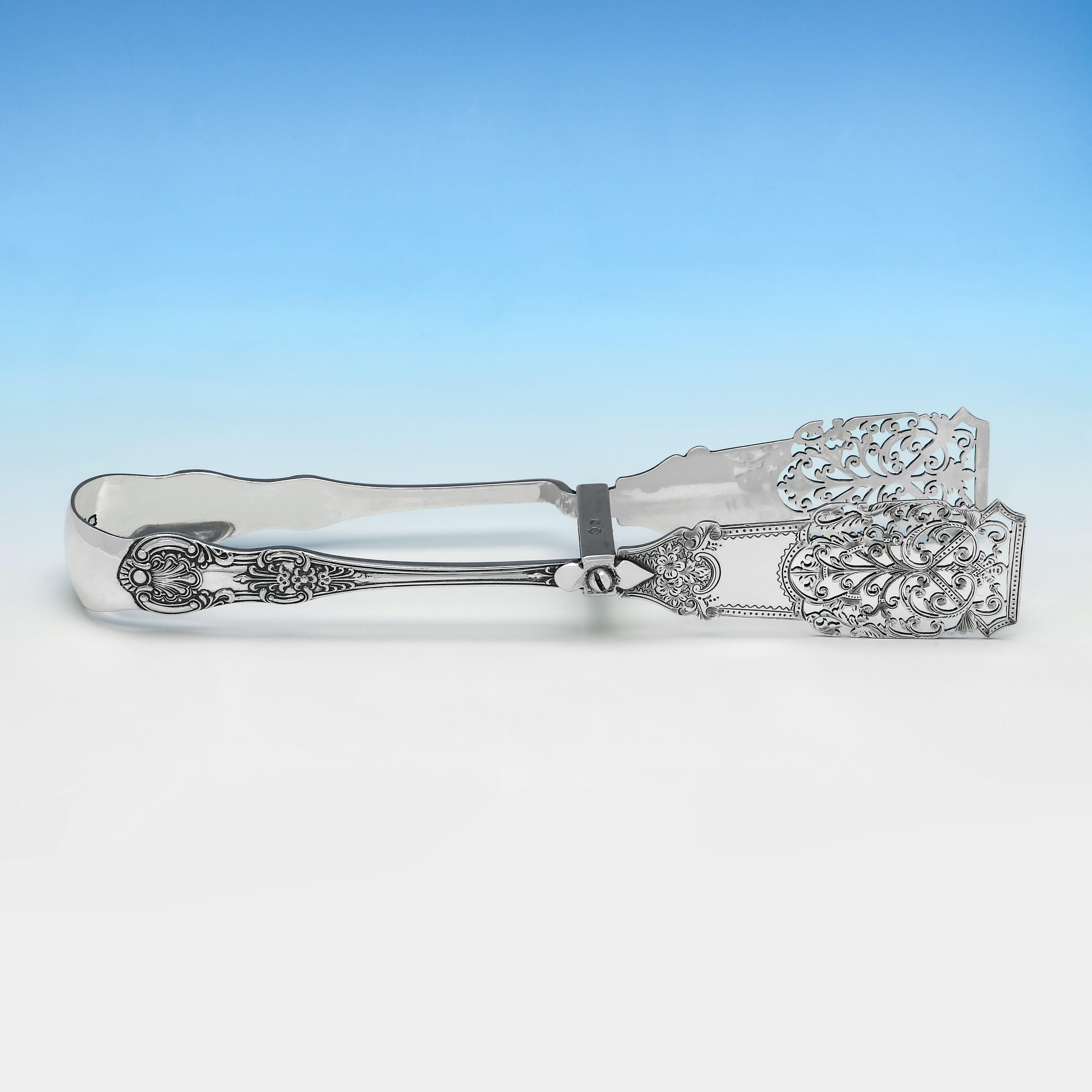 Hallmarked in London in 1898 by William Hutton & Sons Ltd. This handsome pair of Antique, Victorian Sterling Silver Asparagus Tongs, are in 'Kings' pattern, and feature pierced and engraved decoration to the tongs. The asparagus tongs measure