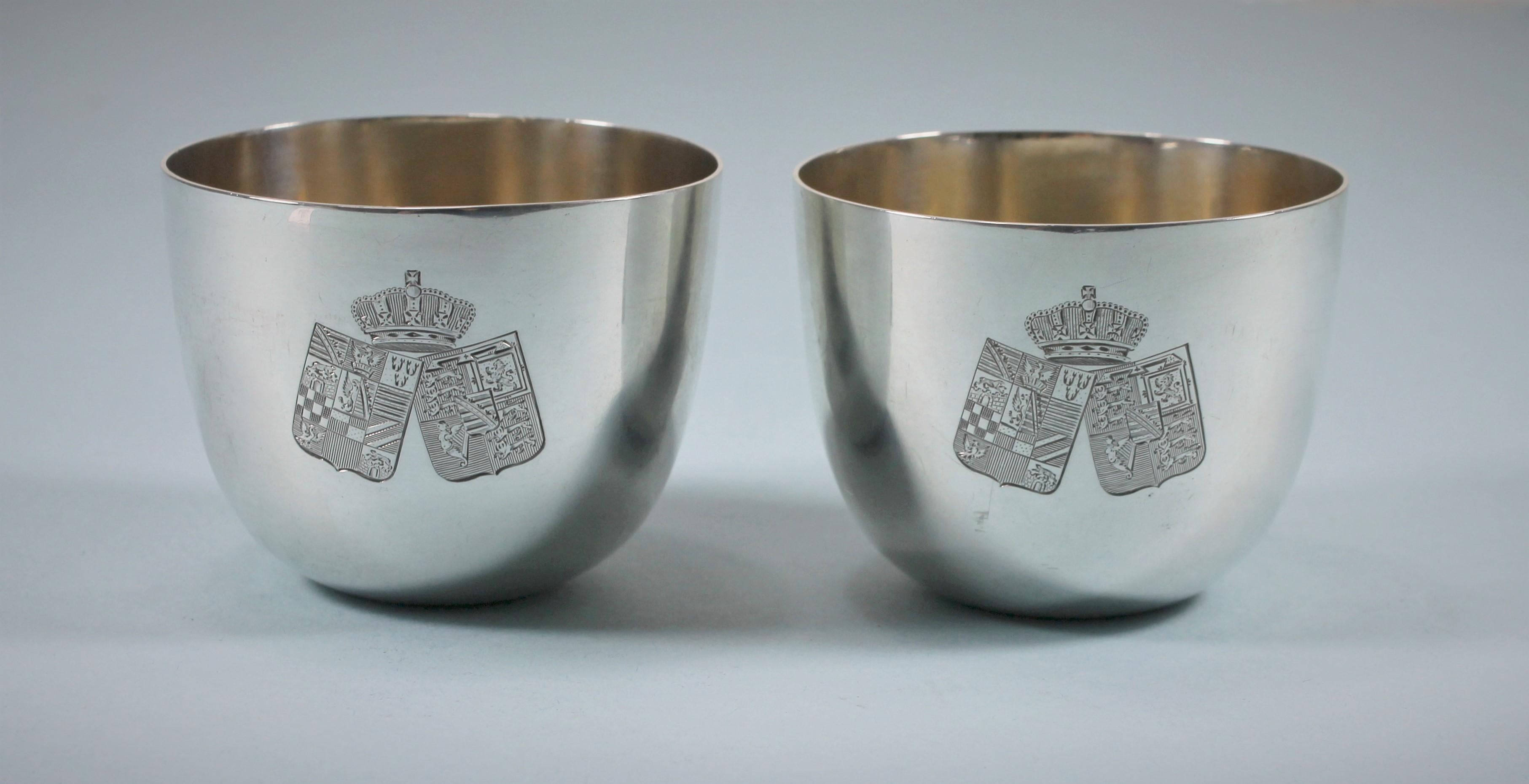 Attractive pair of Victorian sterling silver tumbler cups of good weight.
Makers: JAMES WAKELY & Frank CLARKE Wheeler. London 1891.
The cups are engraved on one side with two coats of arms surmounted by a Duke's Coronet.
On the opposite side