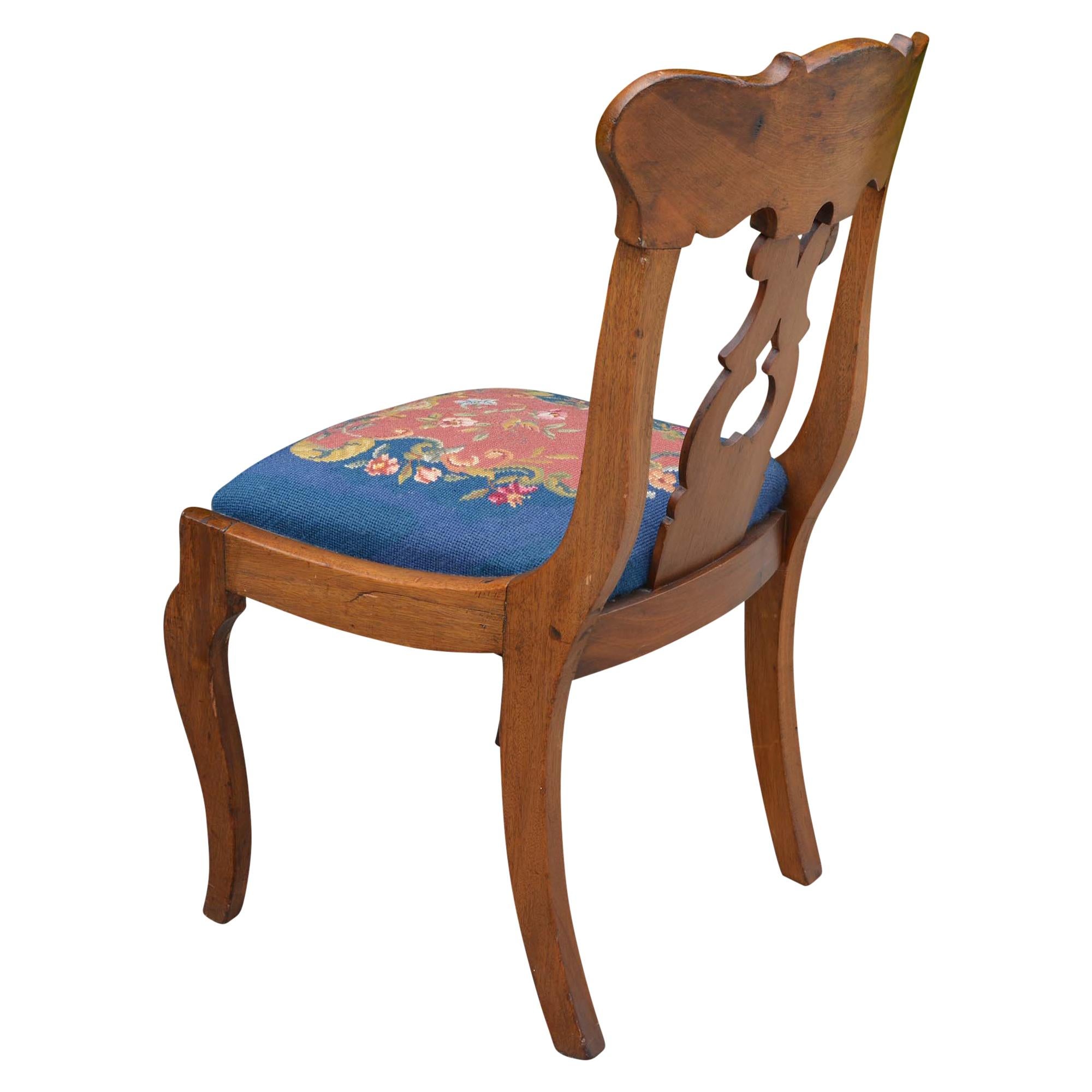 We found this unique parlor chair at an estate sale. The wood tone works so well with the color of the needlepoint seat. The back support has an open design which adds additional character.