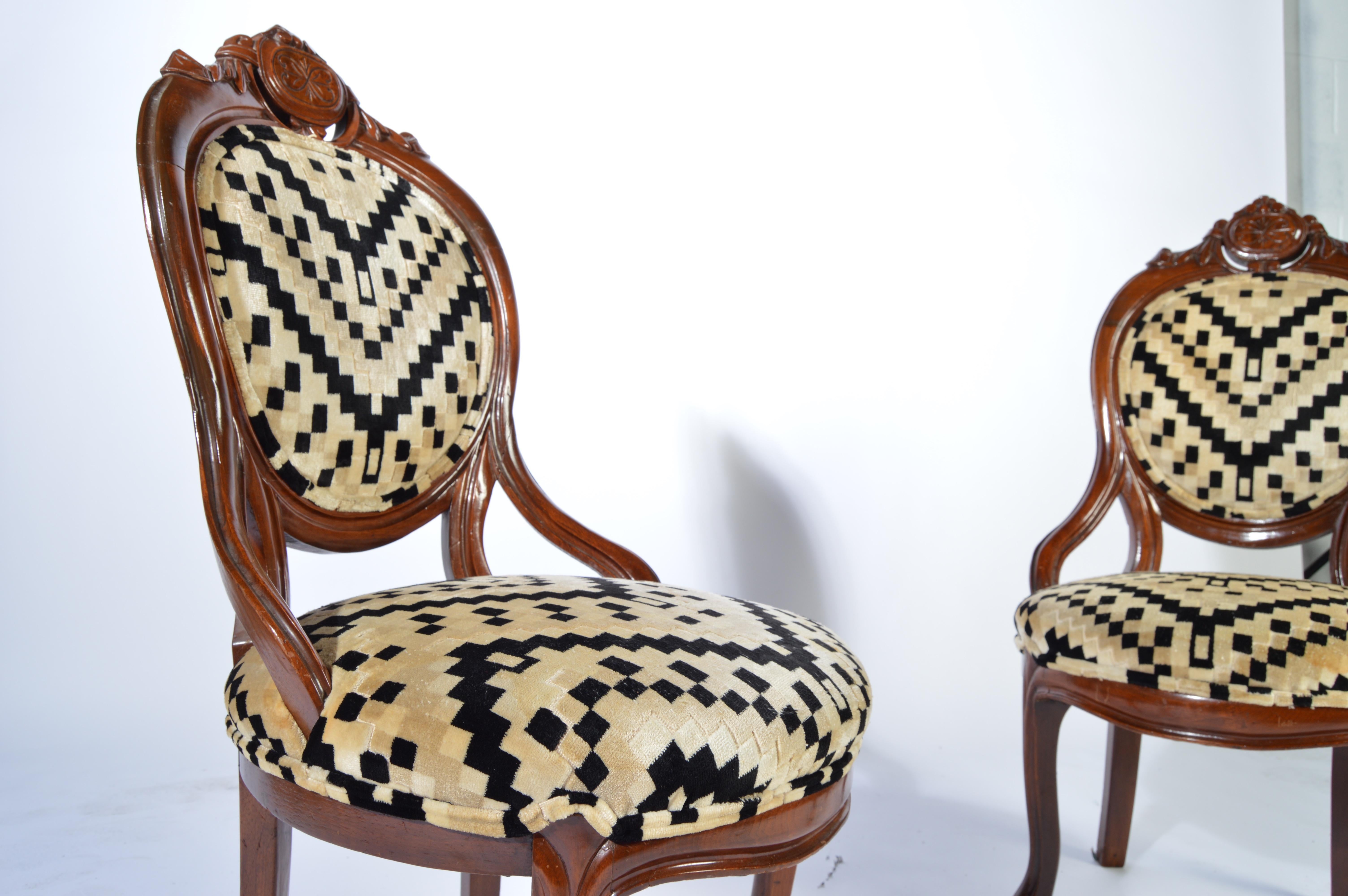 A beautiful antique pair of Victorian parlor chairs having sculpted mahogany frames and stunning original Art Deco velvet upholstery, circa 1930. Absolutely stunning and in fabulous condition having solid frames soft, clean upholstery and firm