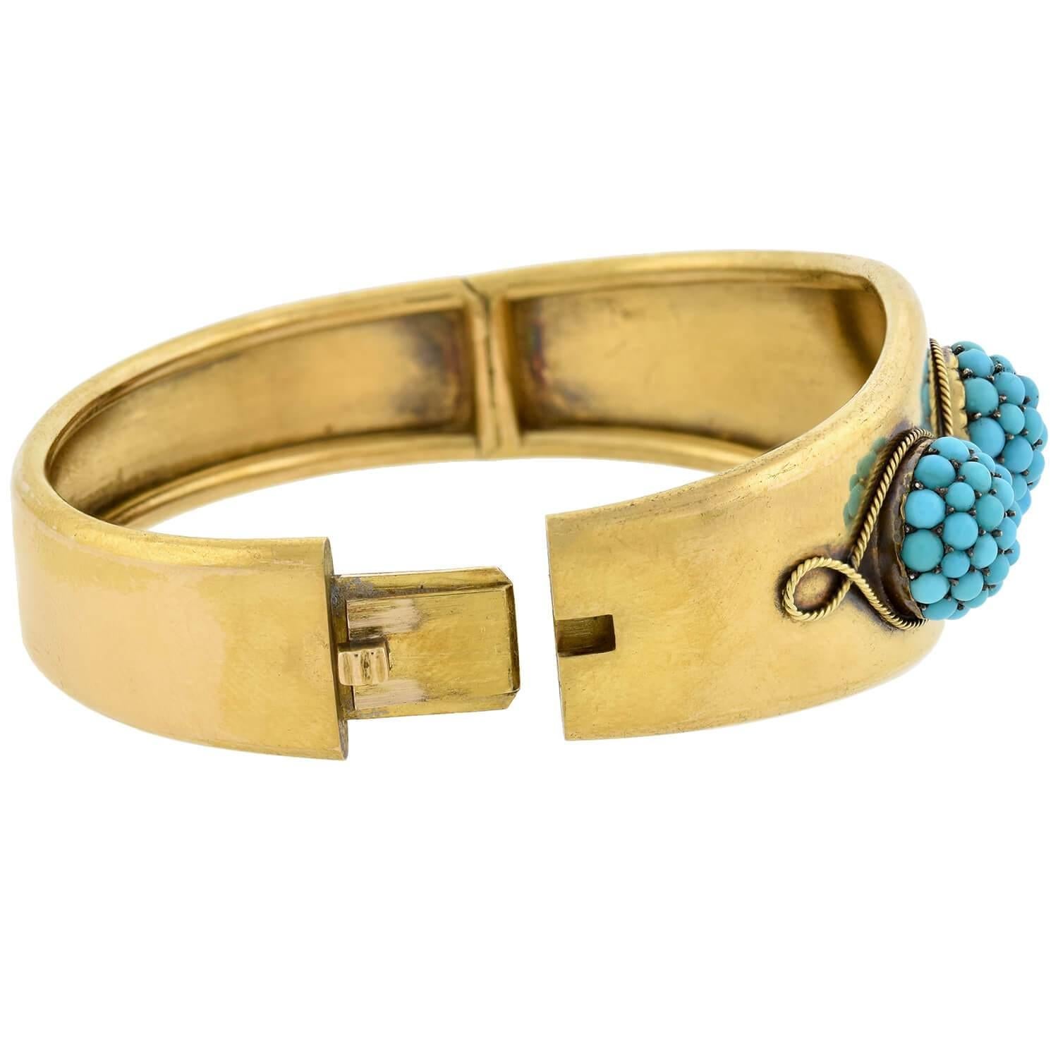 A striking turquoise bracelet from the Victorian (ca1880s) era! Crafted in rich 18kt yellow gold, this stunning piece features a belly-front style adorned with three domed shapes encrusted with pavé turquoise. A twisted gold rope carries across the