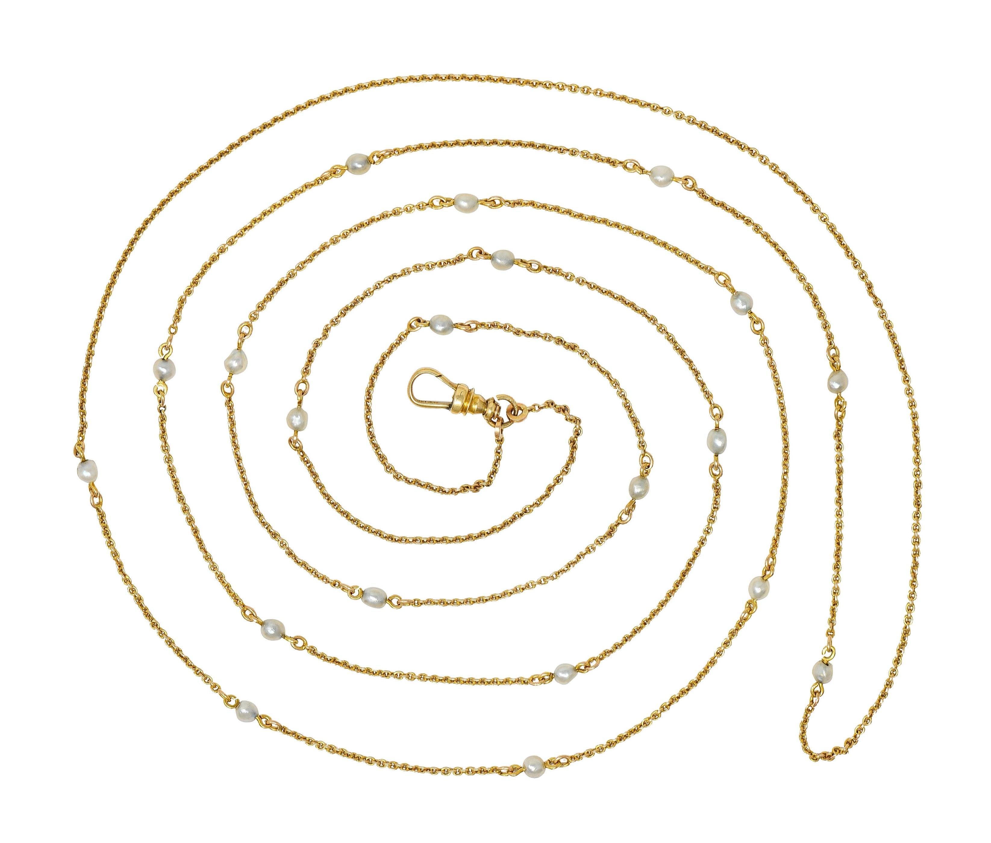 Comprised of 1.5 mm cable link chain 
Featuring twenty pearl bead stations 
Ranging in size from 3.0 to 5.0 mm
White with moderate iridescence
Completed by large antique fob-style lobster clasp
Stamped for 14 karat gold
With maker's mark
Circa: