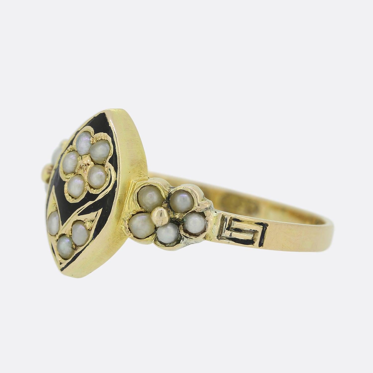 This is a wonderful 15ct yellow gold antique ring. The face is crafted in a navette style and features a flower formed of small seed pearls. Surrounding the daisy there is well kept black enamel which could signify that the ring was original used