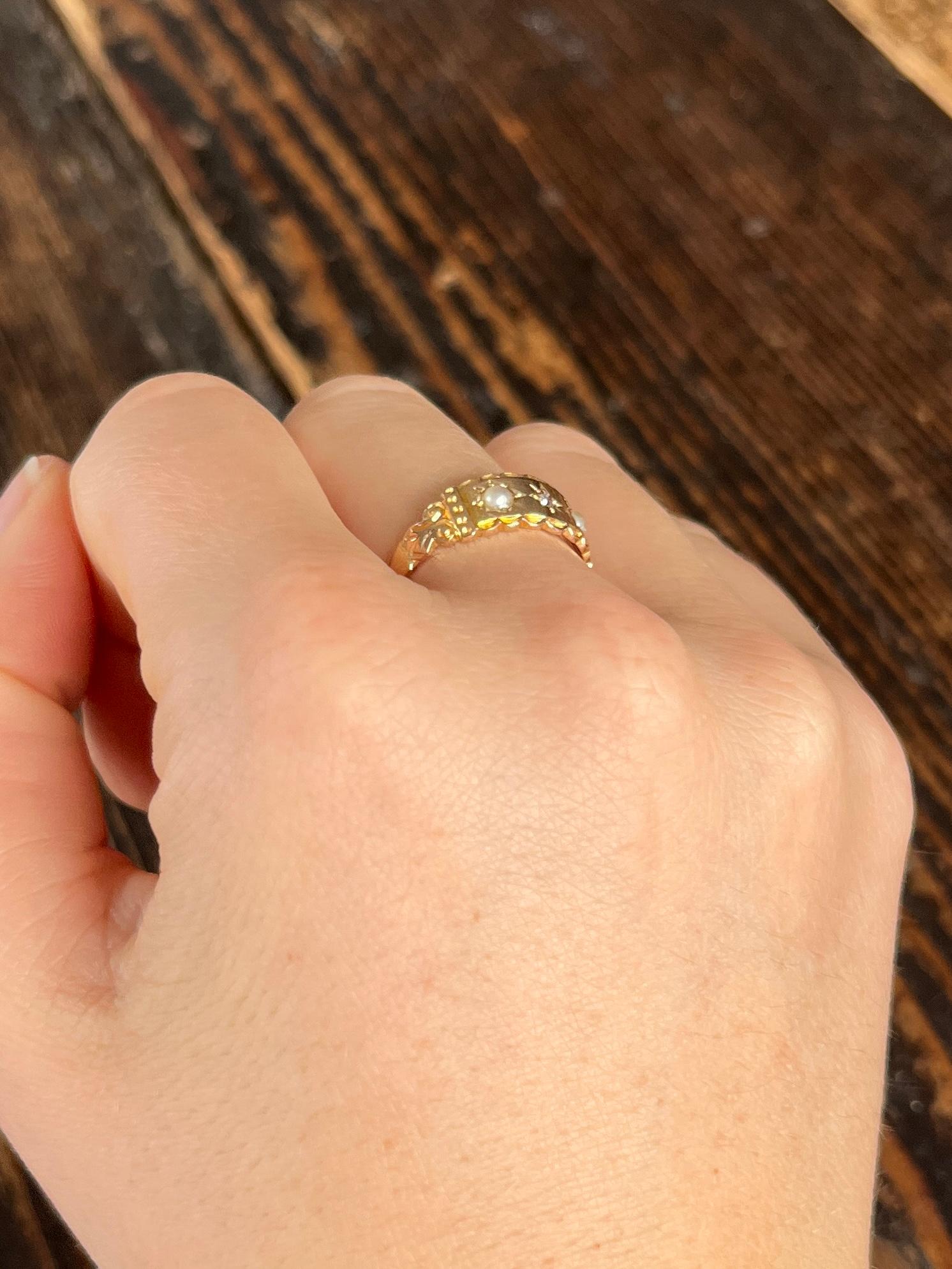 This wide 15ct gold band holds two lovely pearls that sit in either side of a sparkly 3pt diamond. Hallmarked Chester 1894.

Ring Size: N or 6 3/4
Band Width: 7mm

Weight: 2.1g