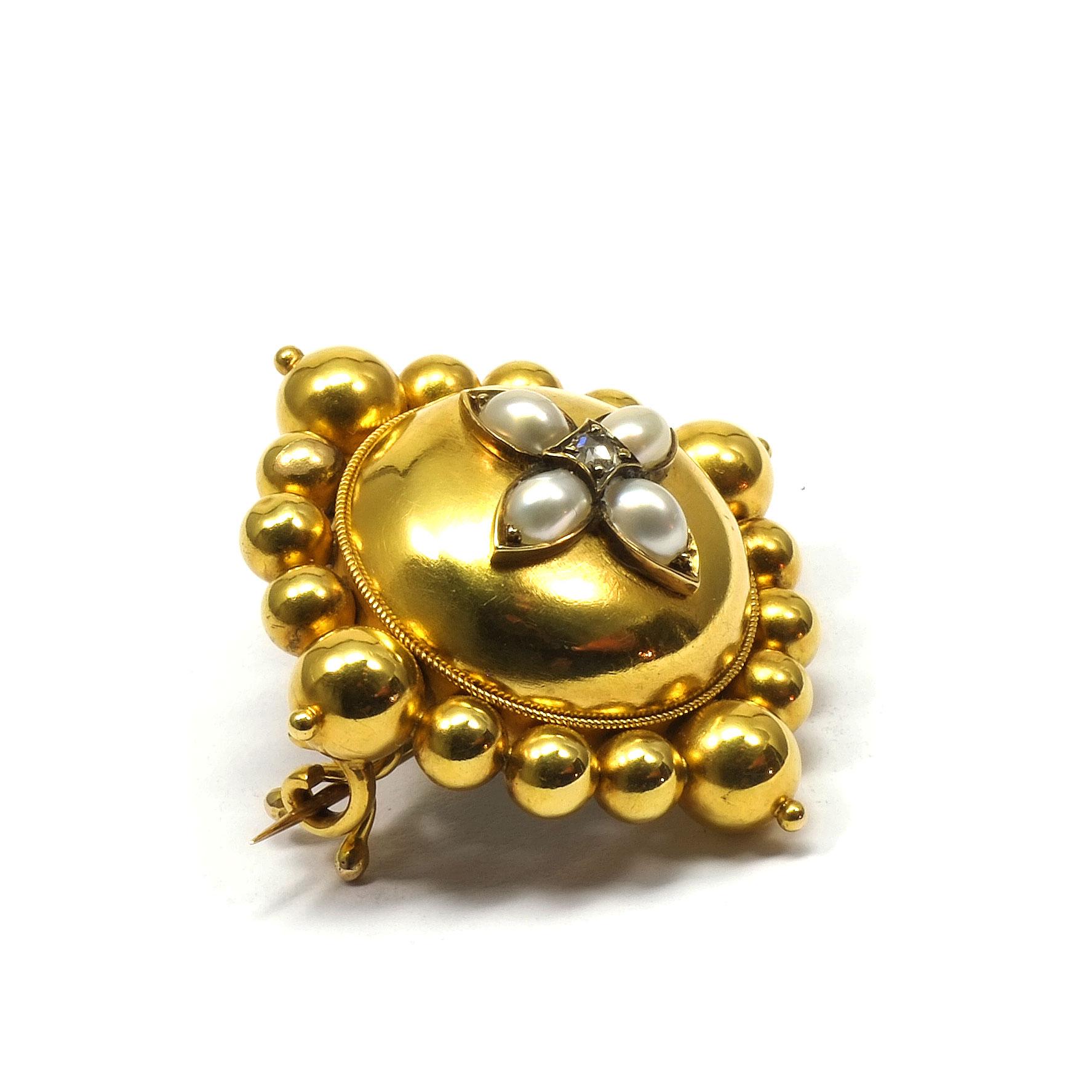 Victorian Pearl and Diamond 18K Gold Brooch circa 1840

Very decorative brooch made of embossed gold, the center worked as a hemisphere and star-shaped with four pearls and a radiant rose-cut diamond, in a setting of gold balls lined up next to each
