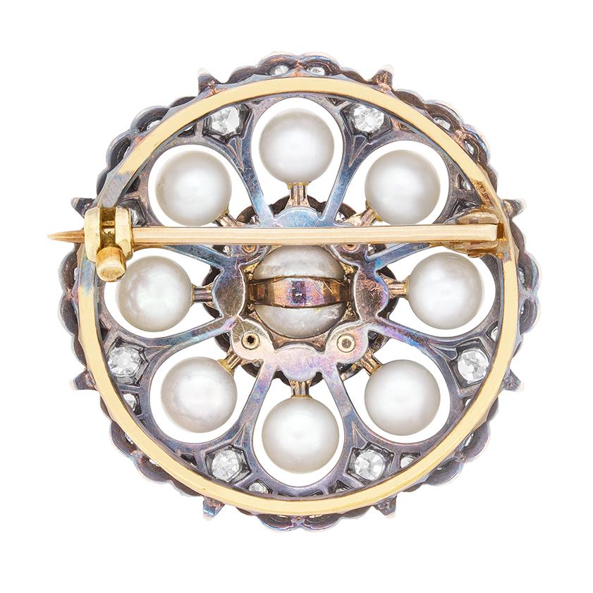 A handmade brooch dating back to the 1880s. This delicate piece of jewellery consists of old cut diamonds and natural pearls. The centre pearl measures 6.5mm, whilst the eight in the surrounding cluster are a little smaller, each measuring 5.00mm.