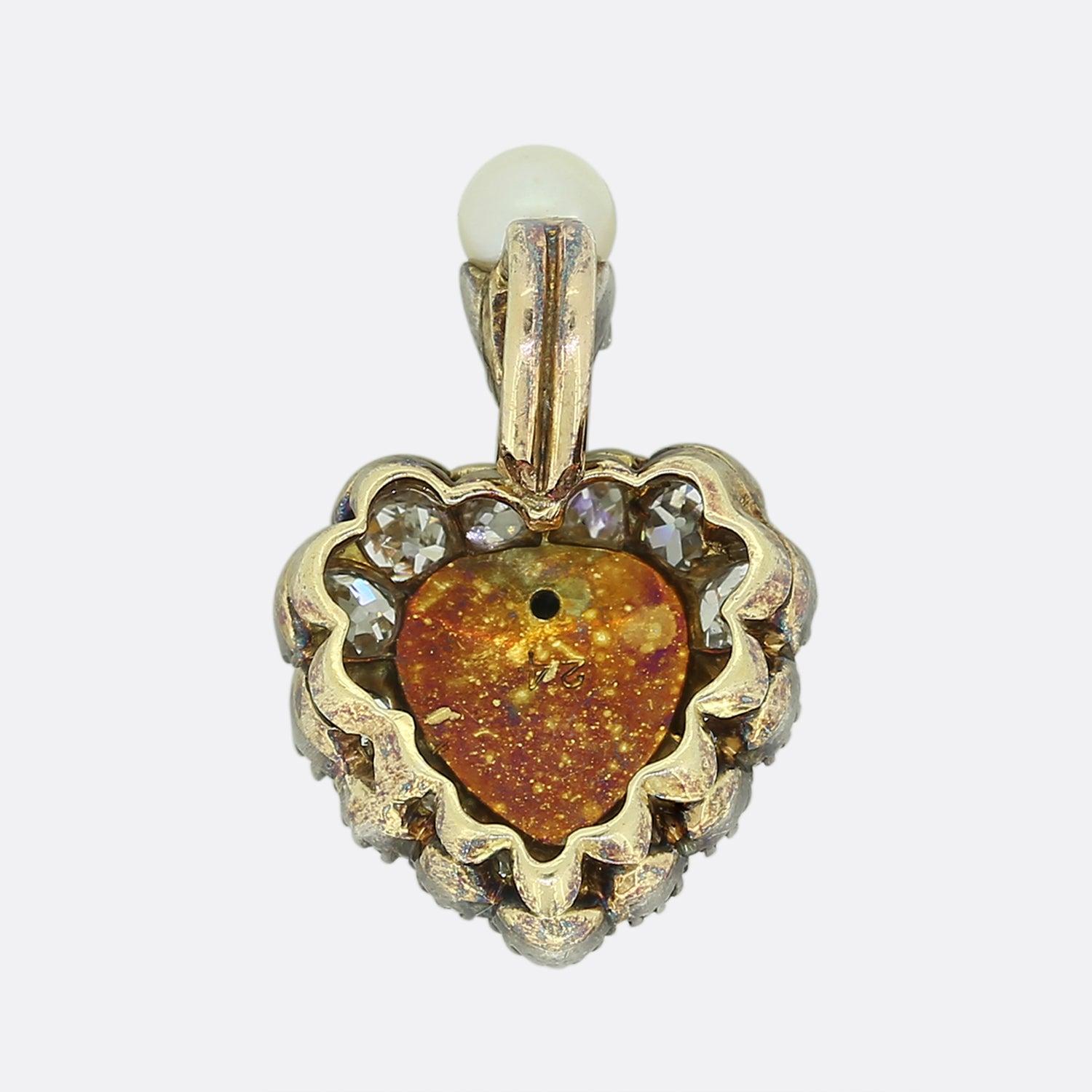 Here we have an antique pendant from the Victorian era. This charming piece has been crafted into the shape of a love heart and boasts a sizeable pear shaped natural silver pearl at the centre. This focal stone is accentuated by a frame of old cut