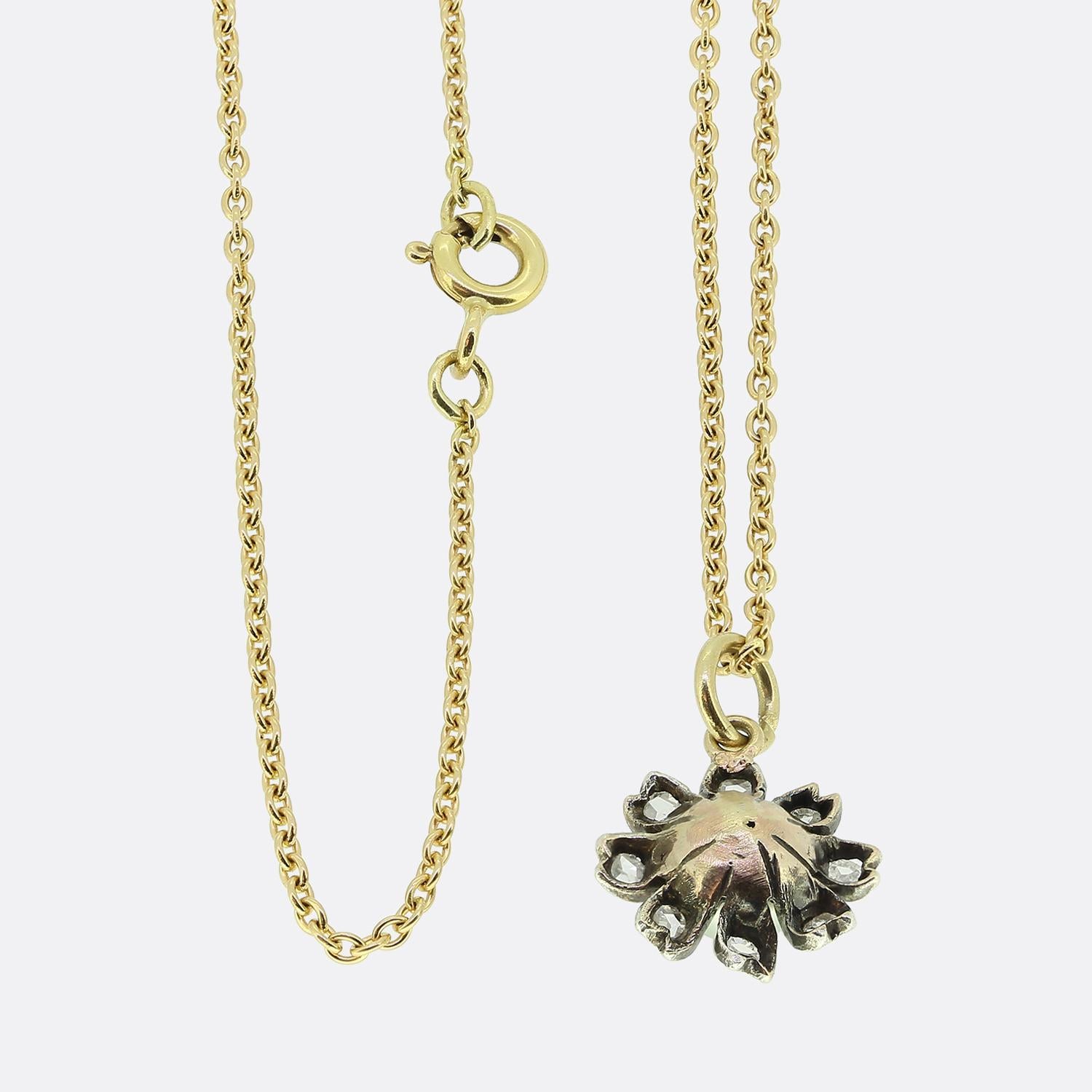 Here we have a delightful pearl and diamond set pendant necklace. This antique pendant has been crafted from yellow gold into the shape of a flower head and silver set with a single round shaped natural pearl at the centre. This principal stone