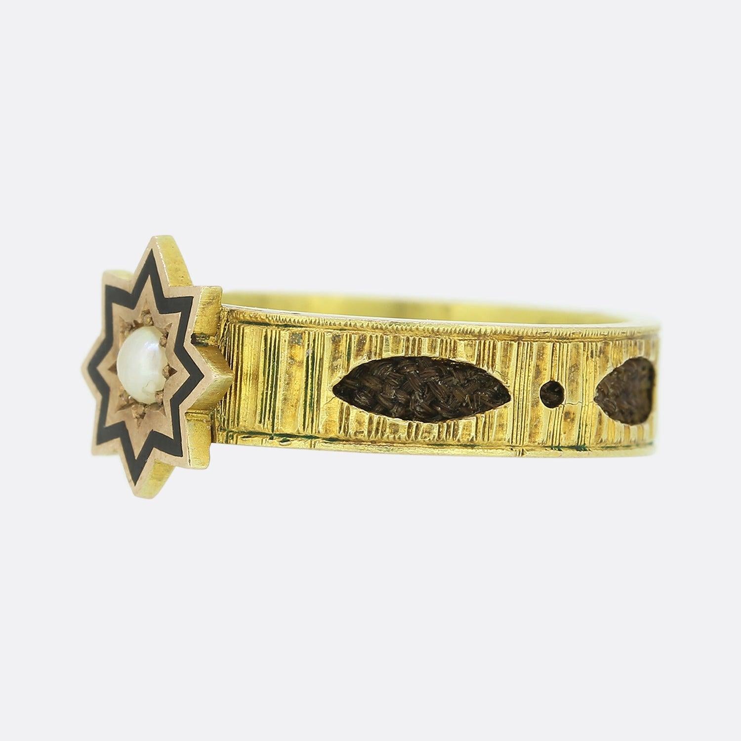 This is a wonderful mourning ring from the mid Victorian era. The head of the ring showcases an 8 pointed star which has been expertly enamelled and plays host to a centralised claw set round natural pearl. This piece gains its real character from