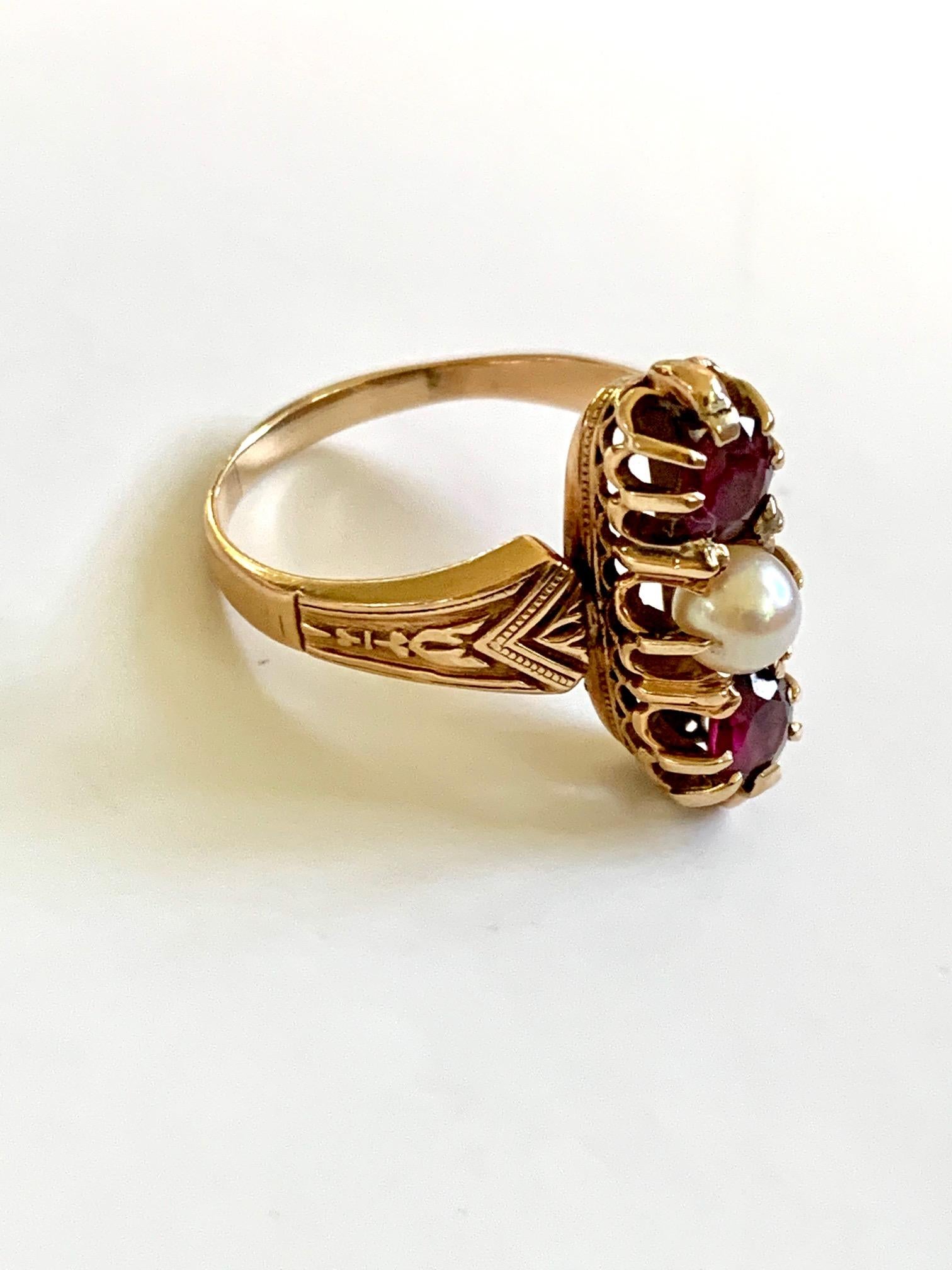 Victorian rings are so lovely; the workmanship and detail of the setting is always stunning.  This ring is tested 14 karat Gold.  There is one 6mm Pearl, in between two faceted 5.5mm Garnets. 

Size: 11 - this ring is resizable but vendor does not