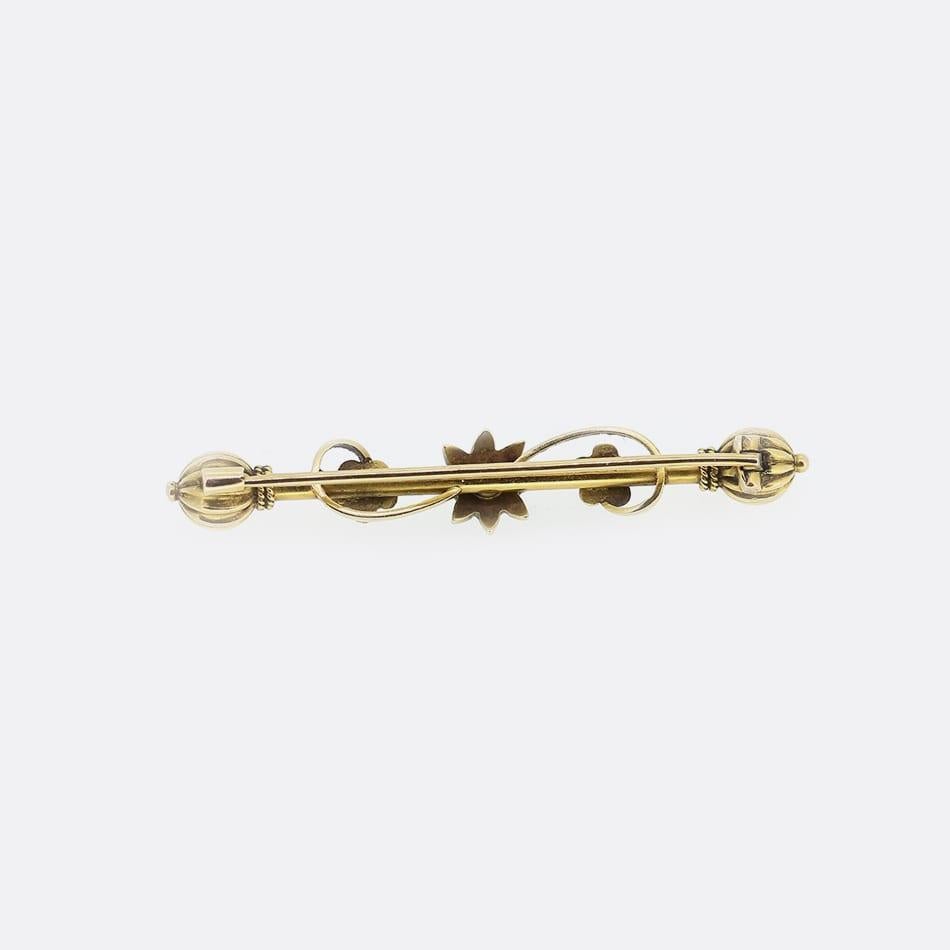This is a Victorian 15ct gold bar brooch. The brooch features a central pearl set star with a pearl set flower on each side. There is also a beautifully detailed section at each end. All of the pearls are natural seed pearls.

Condition: Used