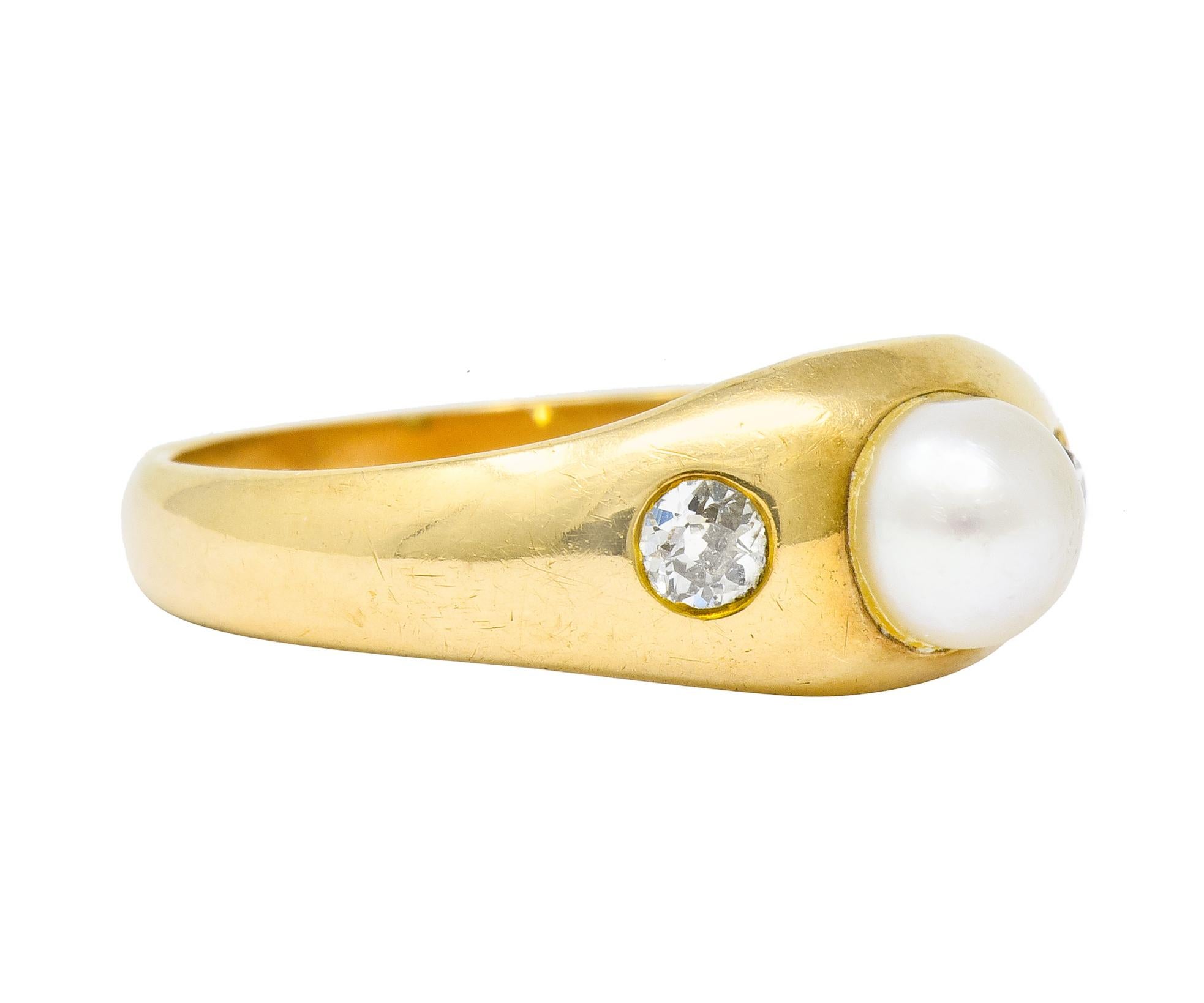 Gypsy style ring centering a 5.2 mm round natural pearl; cream in body color with strong rosé overtones

Flanked by two flush set old European cut diamonds weighing in total 0.20 carat; I and K in color with VS and SI clarity

Tested as 14 karat