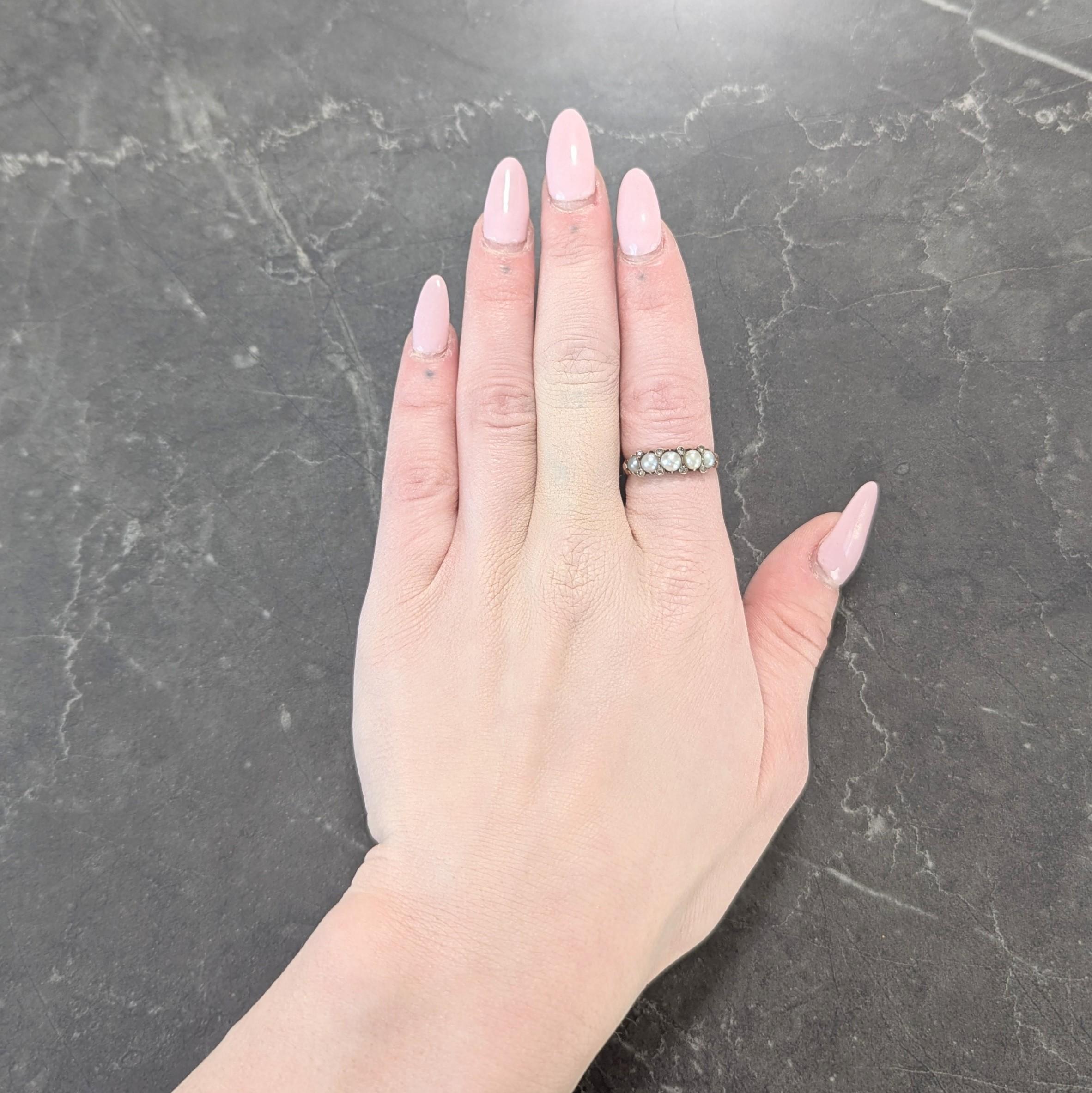 Centering five near-round button pearls set with belcher prongs east to west
Graduated and ranging in size from 3.0 to 4.5 mm
White, cream, and gray in body color with strong iridescence
Accented by rose cut diamonds flush set in between
Weighing