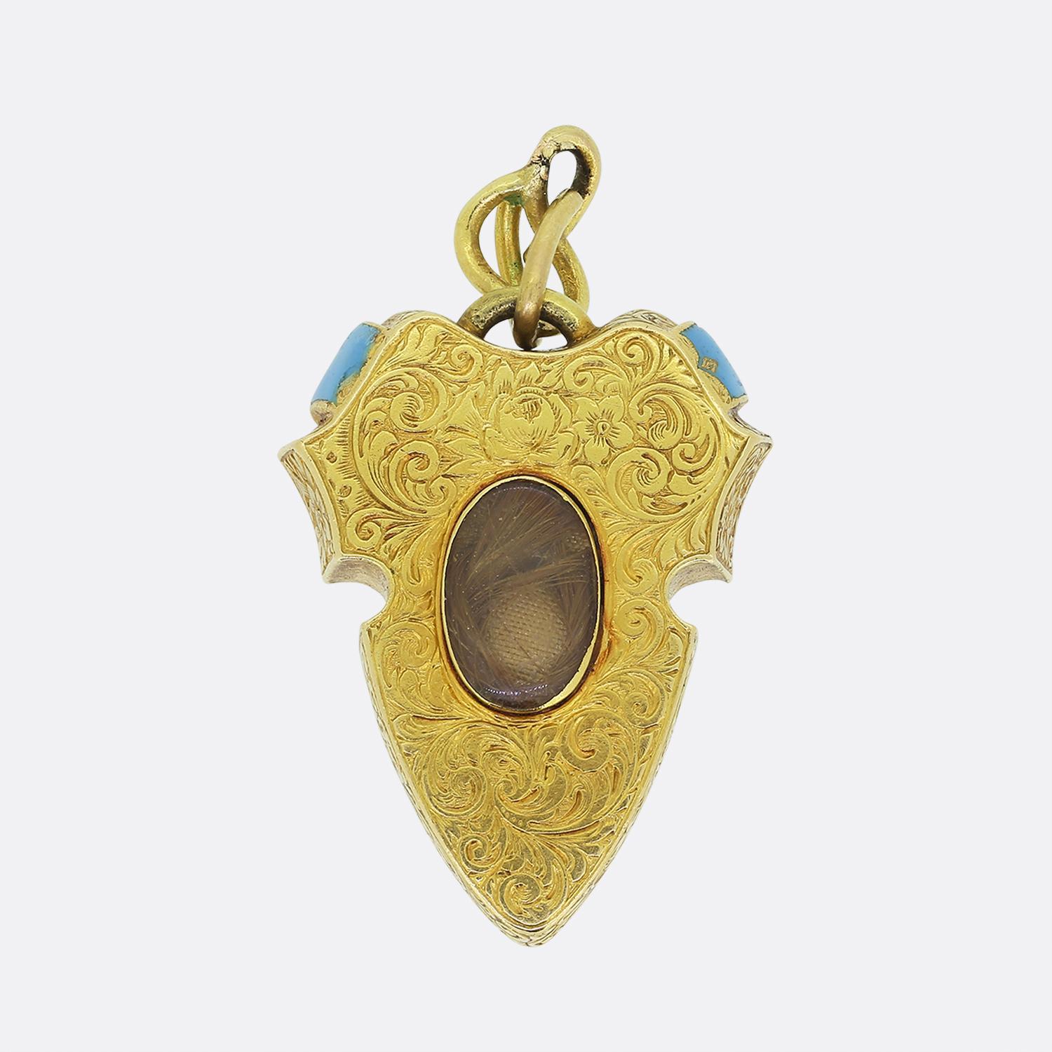 Here we have a remarkable creation taken from the Victorian era. This unique antique pendant has been crafted from a rich 18ct yellow gold into the shape of a shield which plays host to a natural pearl and diamond set buckle motif. Rich sky blue