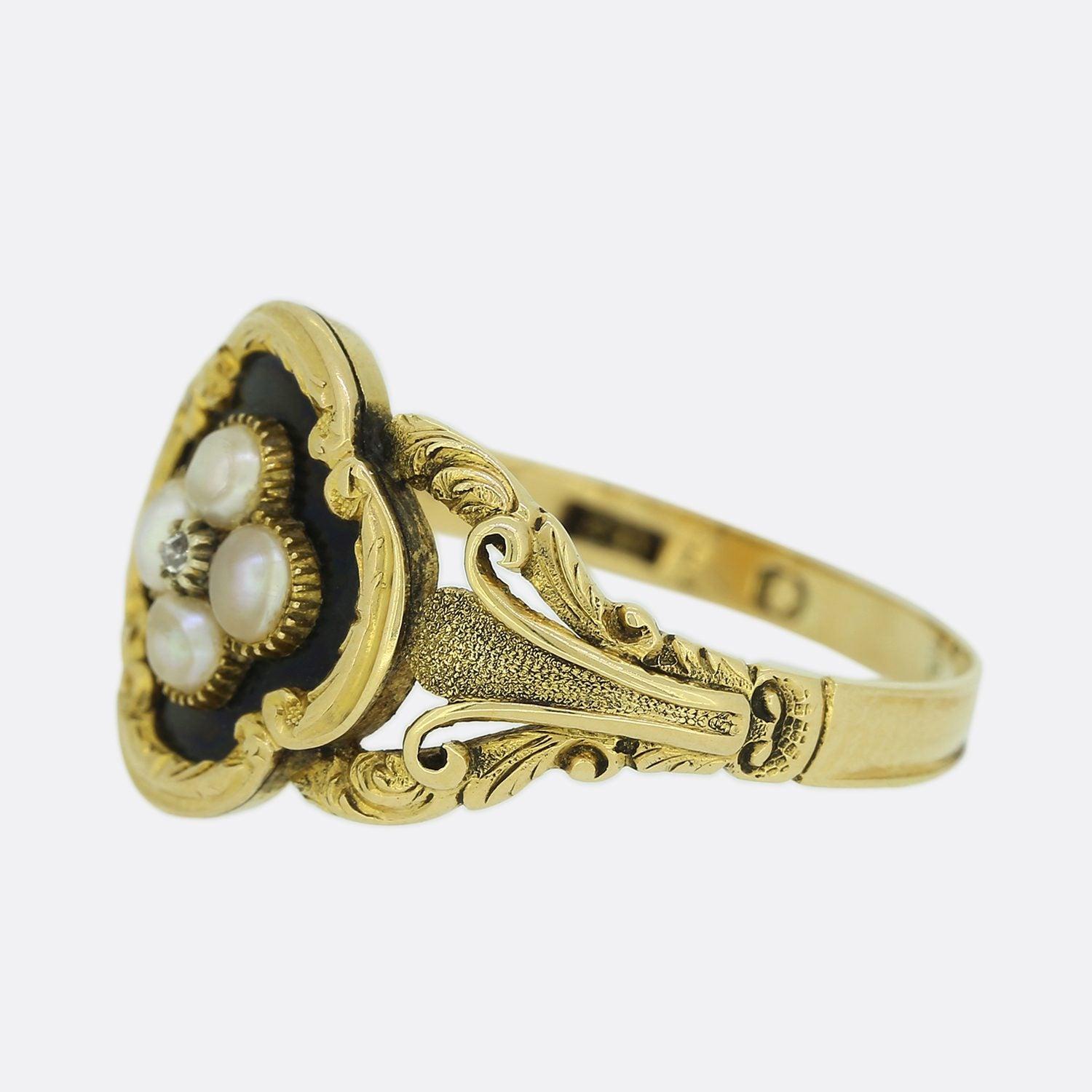This is a wonderfully hand made yellow gold Victorian mourning ring. The ring is set with a central rose cut diamond in a cut collet setting and is surrounded by four original natural pearls in a quatrefoil shaped face. The inside of the ring is