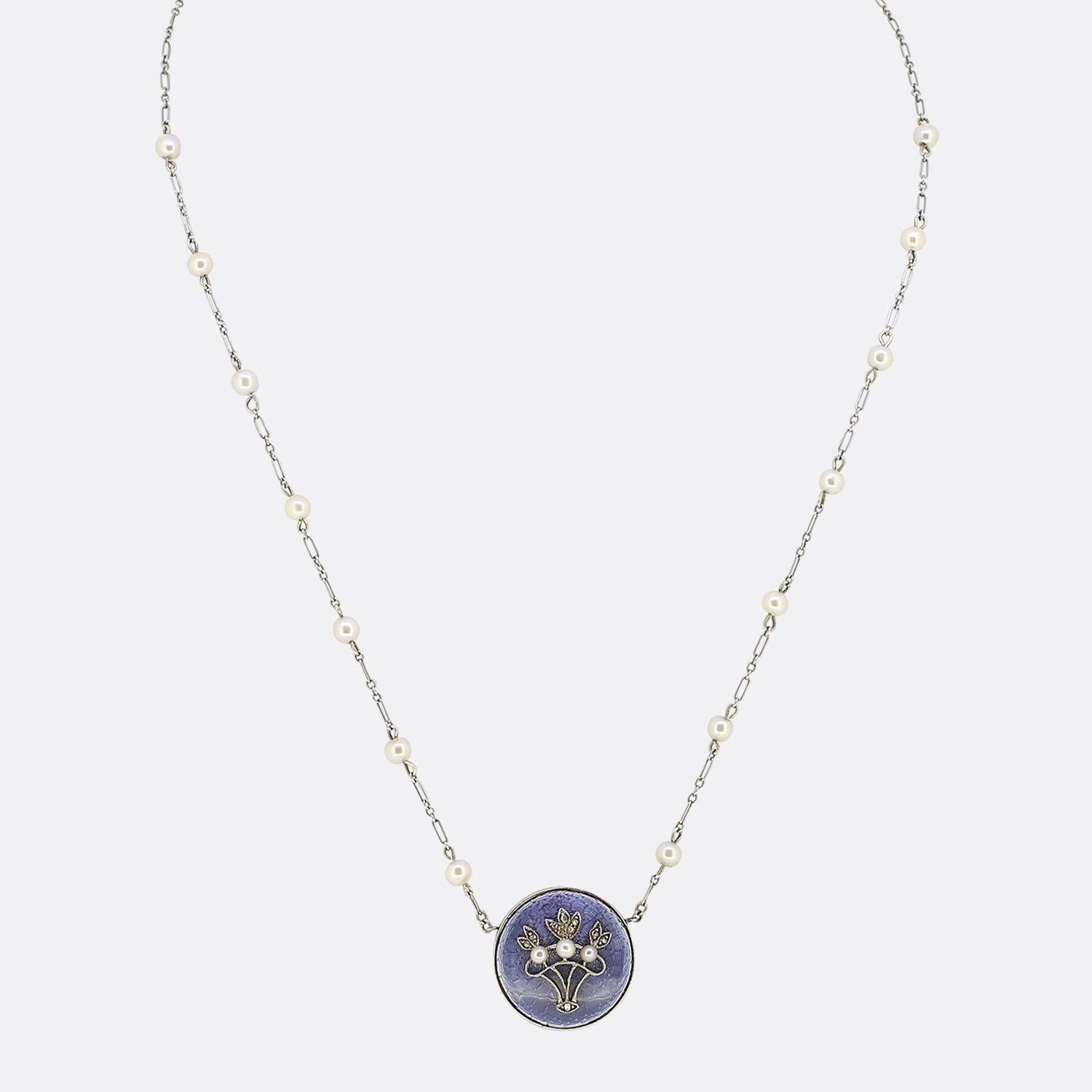 This is a Victorian 18ct gold pearl and diamond necklace. The necklace features a circular face with a blue enamel background and a rose cut diamond set bouquet of flowers crafted in platinum. Additionally, the necklace has been set with three