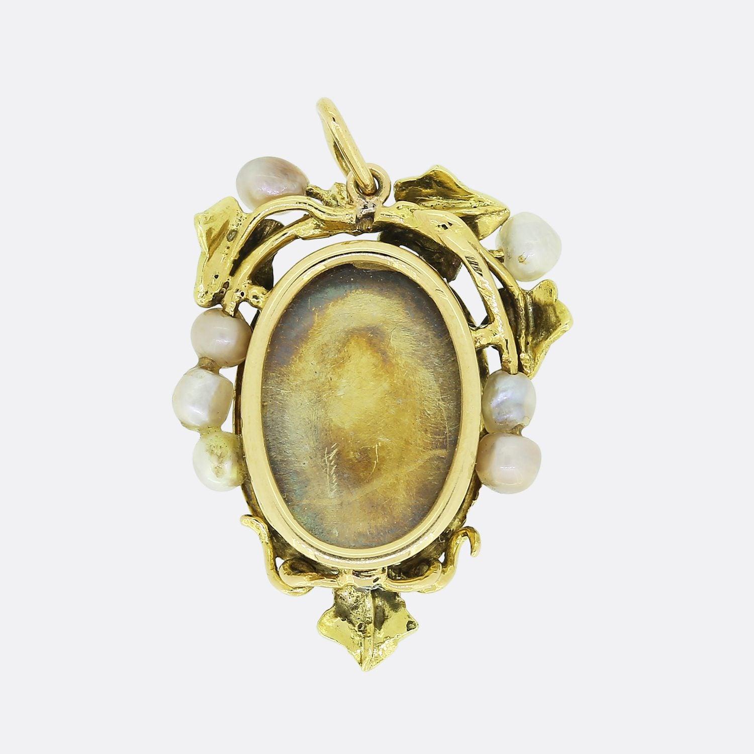 This is a lovely 18ct yellow gold Victorian pendant.  The pendant is in a foliate style and features green enamelled leaves and natural pearls which play the role of the fruit. The pendant is also set with five rose-cut diamonds in the centre. The