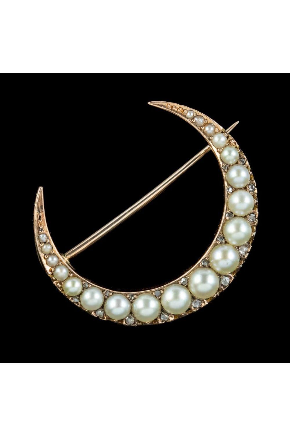 A beautiful antique late Victorian crescent moon brooch (Circa 1900) modelled in 18ct gold and lined with lustrous pearls and twinkling diamonds that graduate in size from each tip.   

Moon images became popular jewellery motifs during the late