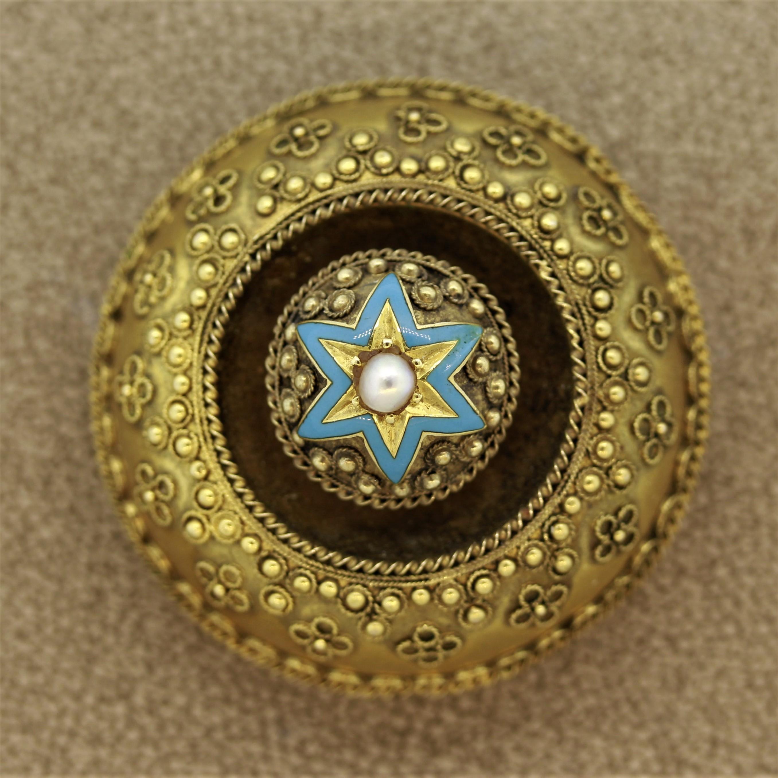 An antique from the Victorian era, circa 1880, featuring a pearl in the center with an enameled star. The centerpiece turns slightly. The back of the piece has a removable piece of glass allowing you to remove it and add a personal photo. It is made