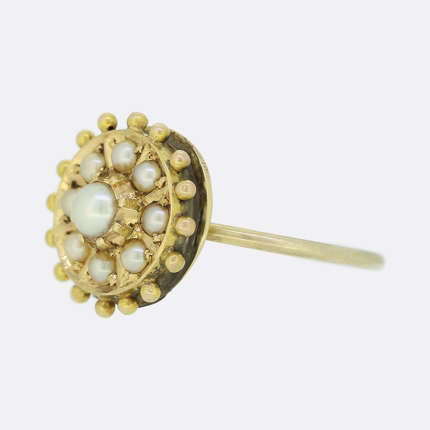 This is a lovely antique Victorian pearl ring. The ring features a central pearl which is surrounded by a further eight pearls in an Etruscan setting crafted in gold. This ring started life as an antique Victorian brooch but has been transformed