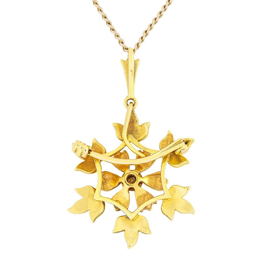Crafted in 15 carat gold around the turn of the century, this beautiful antique necklace takes on the likeness of a blooming flower surrounded by leaves. Twenty five pearl adorn the flowers with an additional three graduating down the bail. As an