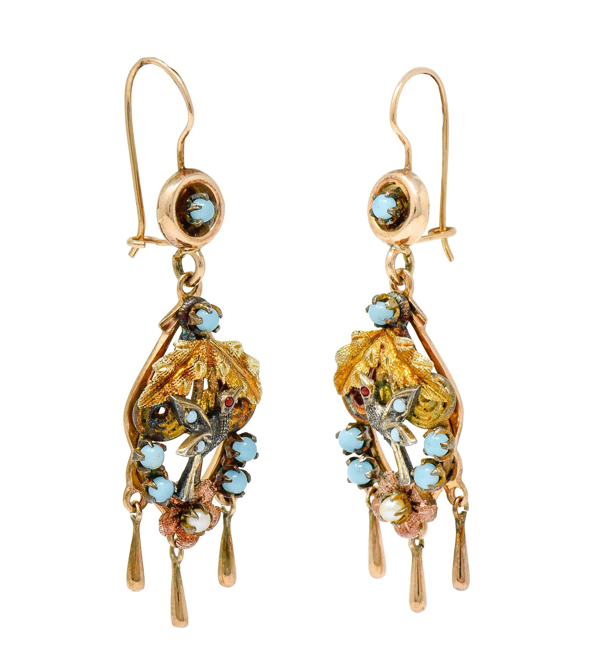 Earrings are designed with a puffed rose gold circular surmount suspending an ornate drop

Depicting a white gold hummingbird with yellow gold leaves and rose gold florals

Featuring translucent and round pastel blue glass cabochons throughout and