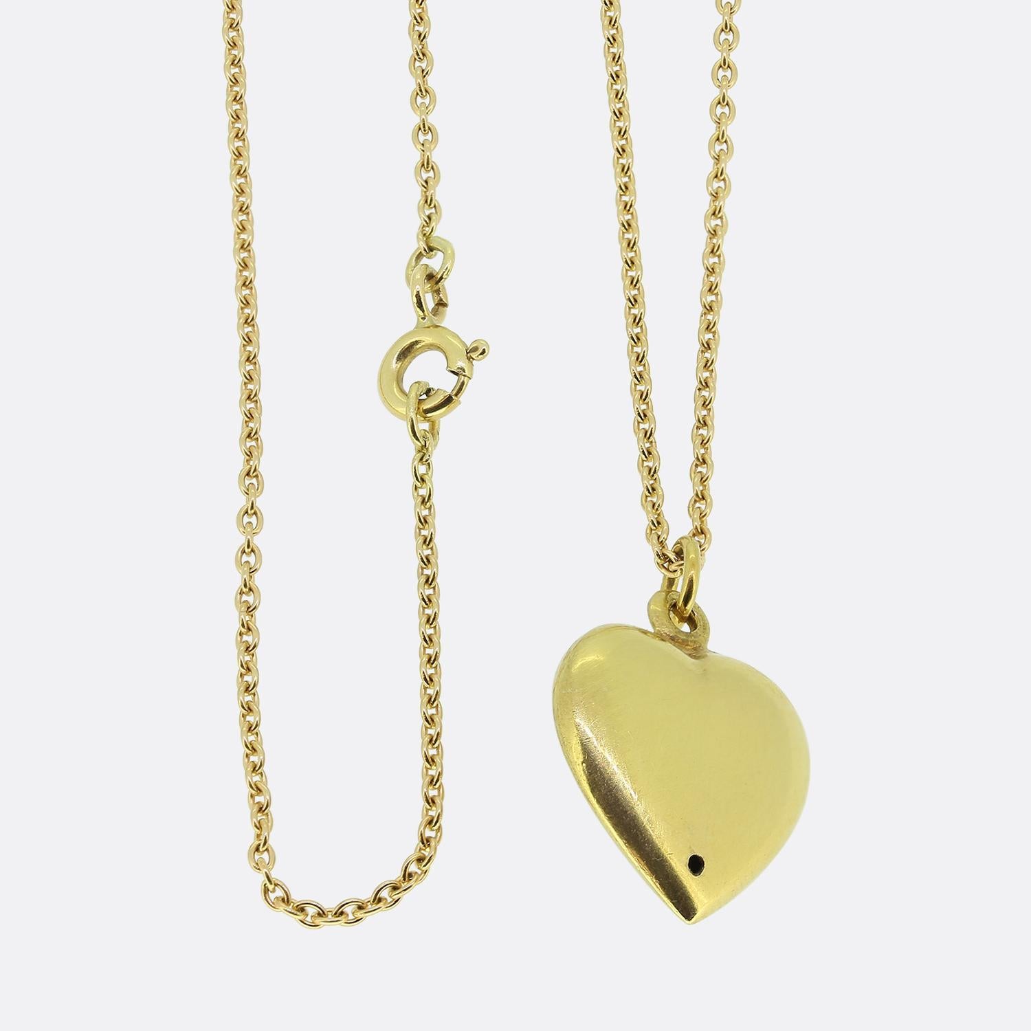 Here we have a beautiful pearl set pendant necklace. This antique pendant has been crafted from 18ct yellow gold into the the shape of a little love heart and expertly set with an array of round natural pearls in a floral formation. This motif sits