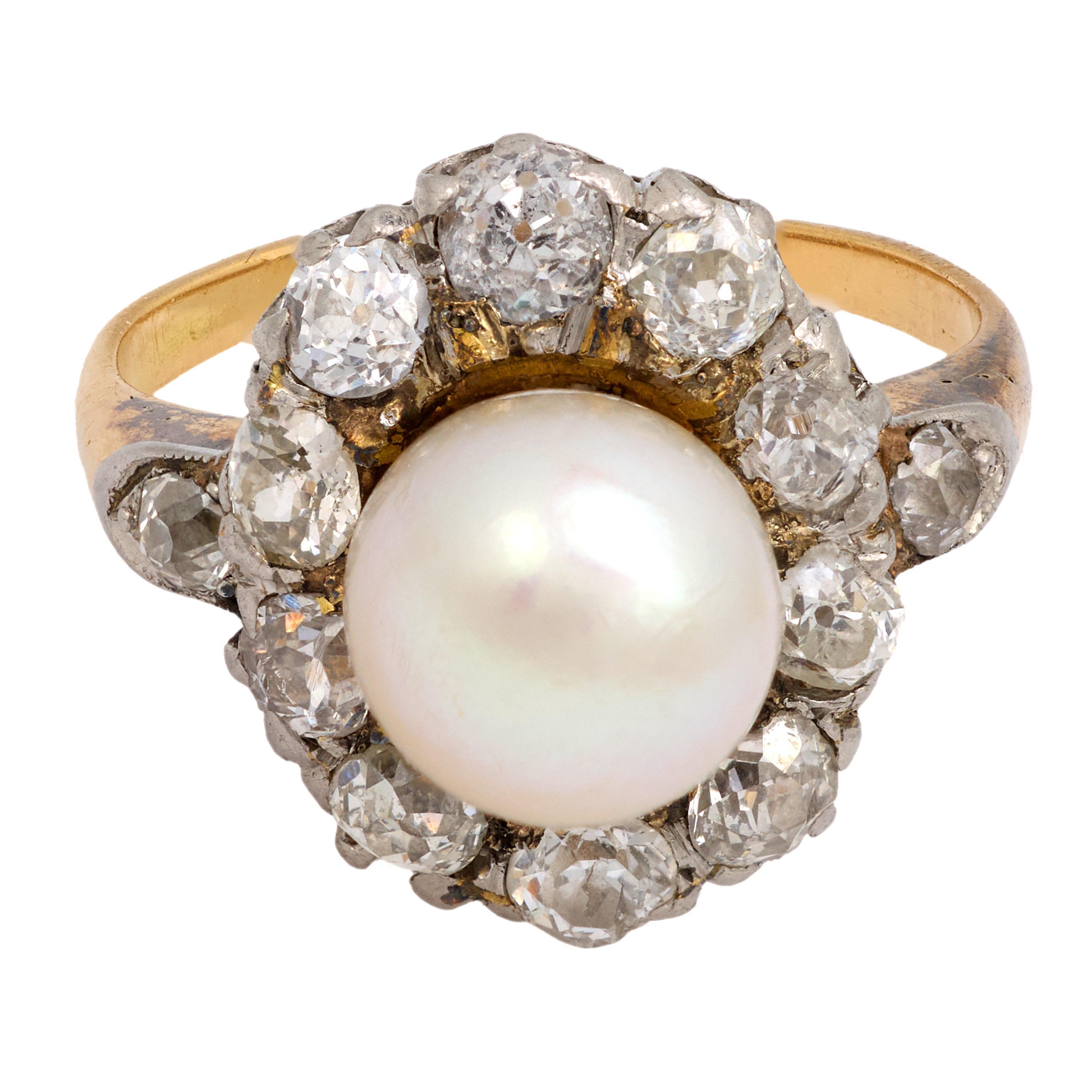 This Victorian ring showcases a luminous 7.20mm pearl surrounded by twelve antique old European cut diamonds, all set in 18k yellow gold with a platinum top. Crafted in the 1880s, it exudes timeless romance and refined antique elegance.

Center