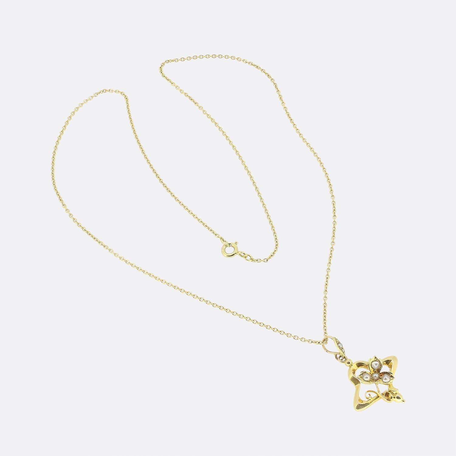 Here we have a lovely pearl set pendant necklace. This antique pendant has been crafted from 15ct yellow gold with an open framework playing host to a clover motif at the centre; each leaf of which is set with a single round shaped natural pearl. A
