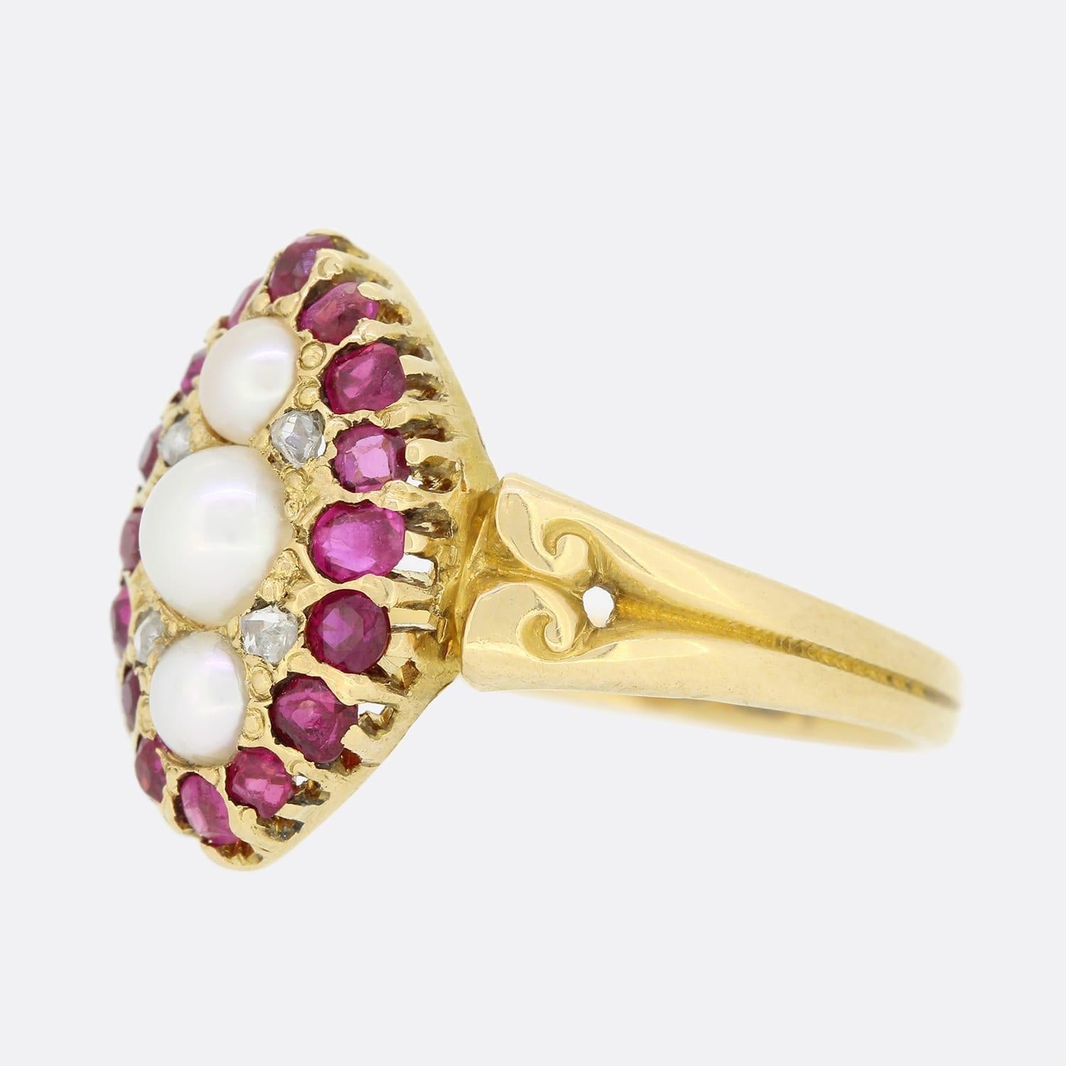 This is a wonderful Victorian 18ct yellow gold navette ring. The ring has been set with 3 central pearls, 4 rose cut diamonds and a border of stunning rich red rubies. The intense red colour of the rubies highly compliments the white lustre of the