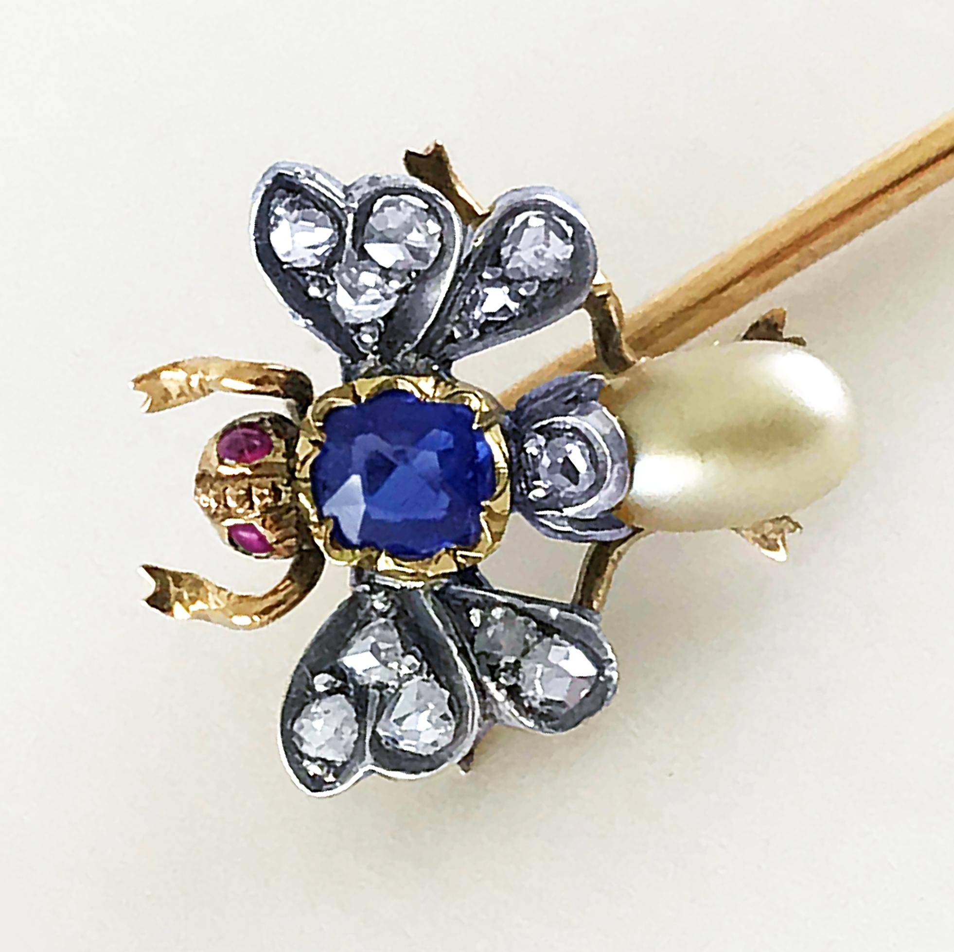 Insect Stick pin in the form of a bee (bug) with ruby eyes, sapphire body, diamond wings and pearl circa 1880.

18ct yellow gold and silver set, intricately formed and set with 2 well matched rubies (natural no heat treatment) for eyes and Rose cut