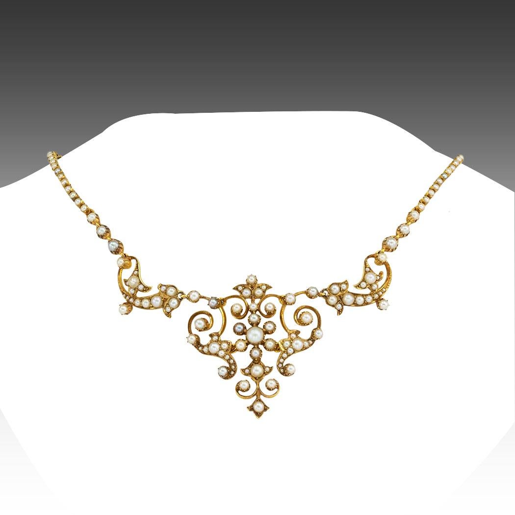 Victorian SEED pearl and yellow gold necklace circa 1890. *

ABOUT THIS ITEM:  #N-DJ93B. Scroll down for specifications.  The front of the necklace comprises an intricate, open work, scrolling motif entirely set with seed pearls of varying sizes,