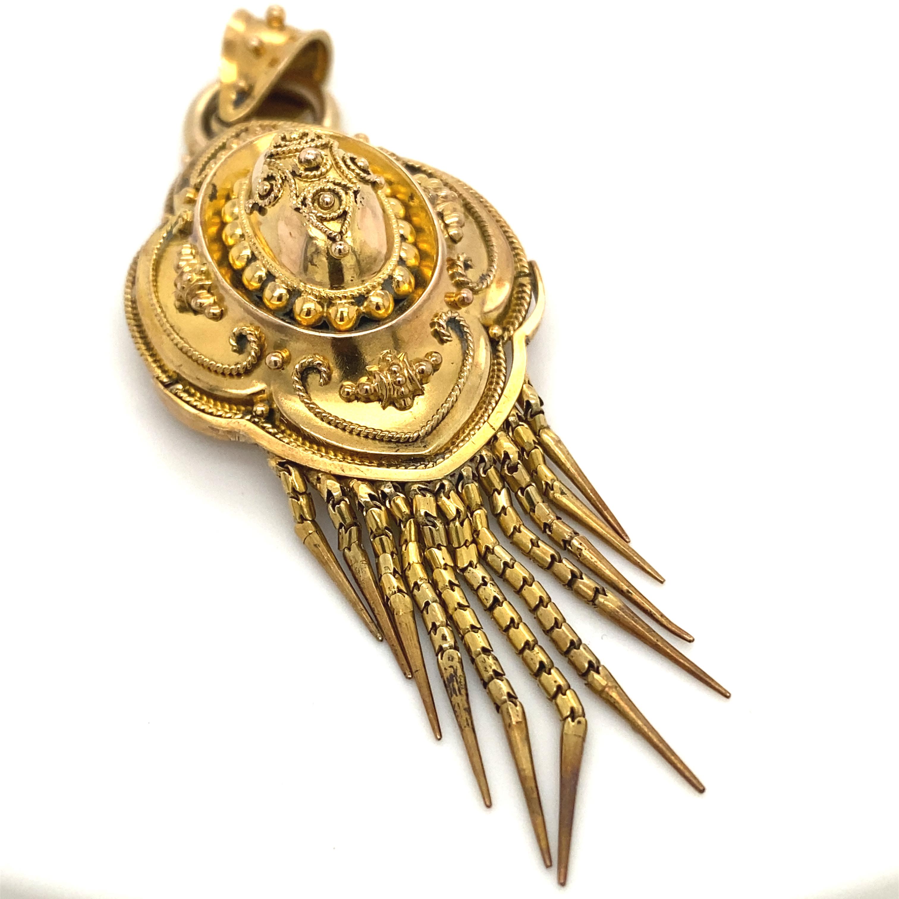 A Victorian pendant in 18 karat yellow gold, circa 1860.

This beautiful Victorian pendant crafted in yellow gold features exquisite granulation and beadwork throughout, with further bead work on the tapered bale.

The back of the pendant has an