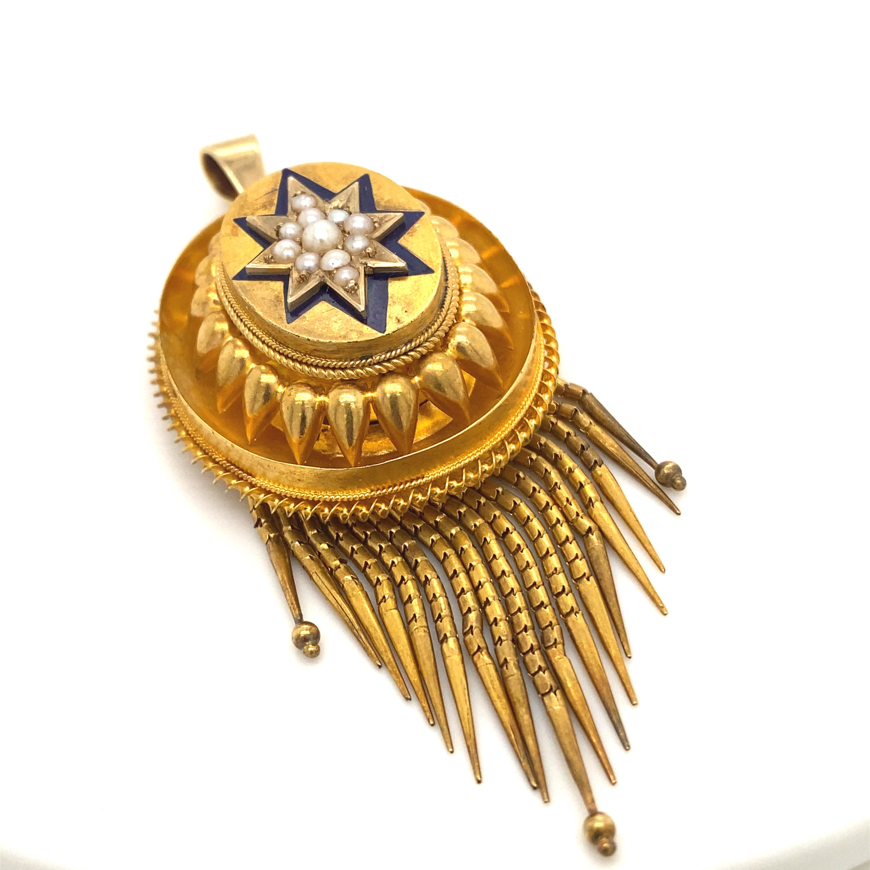 A Victorian pendant in 18 karat yellow gold set with enamel and pearl, circa 1860.

This exquisite Victorian, pendant crafted in yellow gold is in outstanding condition for its age.
Blue enamel work in the form of a star surrounds a cluster of