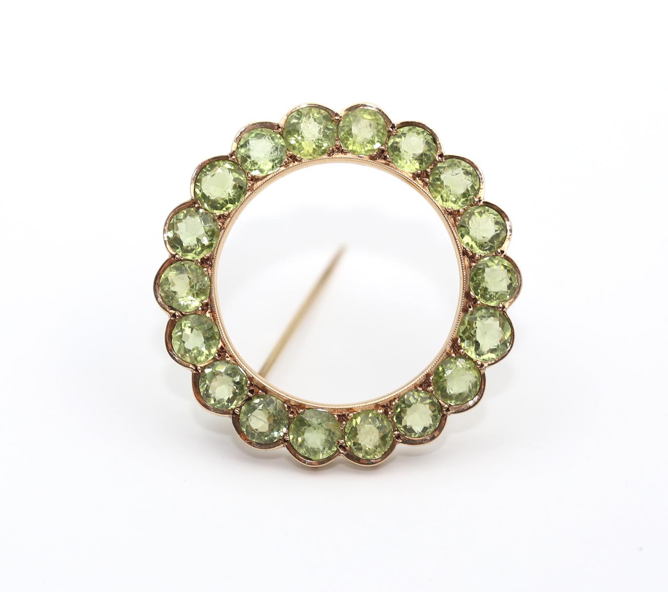 Victorian Peridot Circle Brooch Pin Yellow Gold. Created around 1900. 
A fine antique Peridot circle brooch/pin in Yellow Gold. 
Set all around with a row of round cut fine Peridots. 
No assay marks. The color of the stones is just wonderful and it