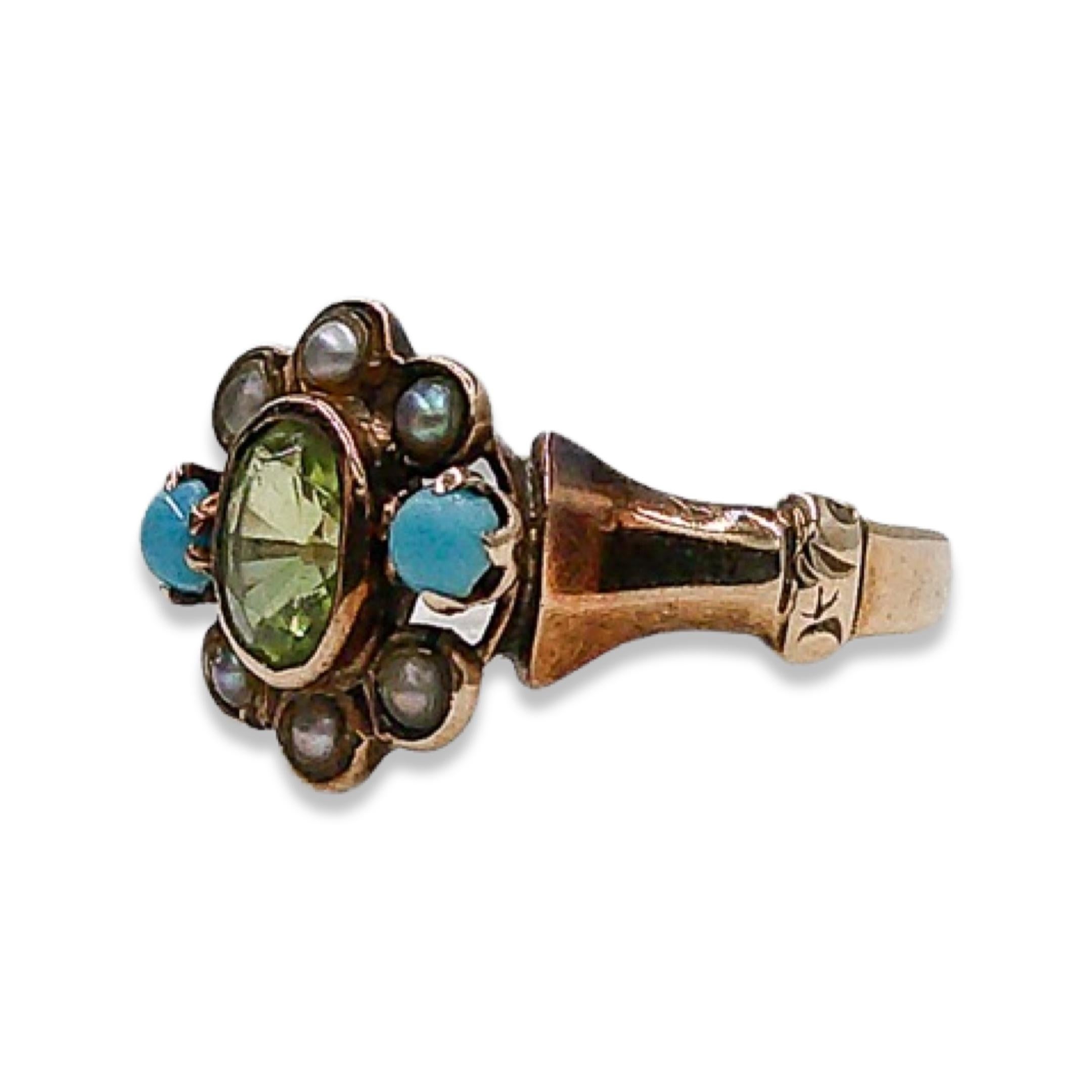 Step into a world of timeless elegance and whimsical allure with this Victorian peridot, pearl, and turquoise ring. Nestled in a bed of lustrous 10k gold, this stunning ring showcases a captivating floral design that exudes vintage charm.
 
At its