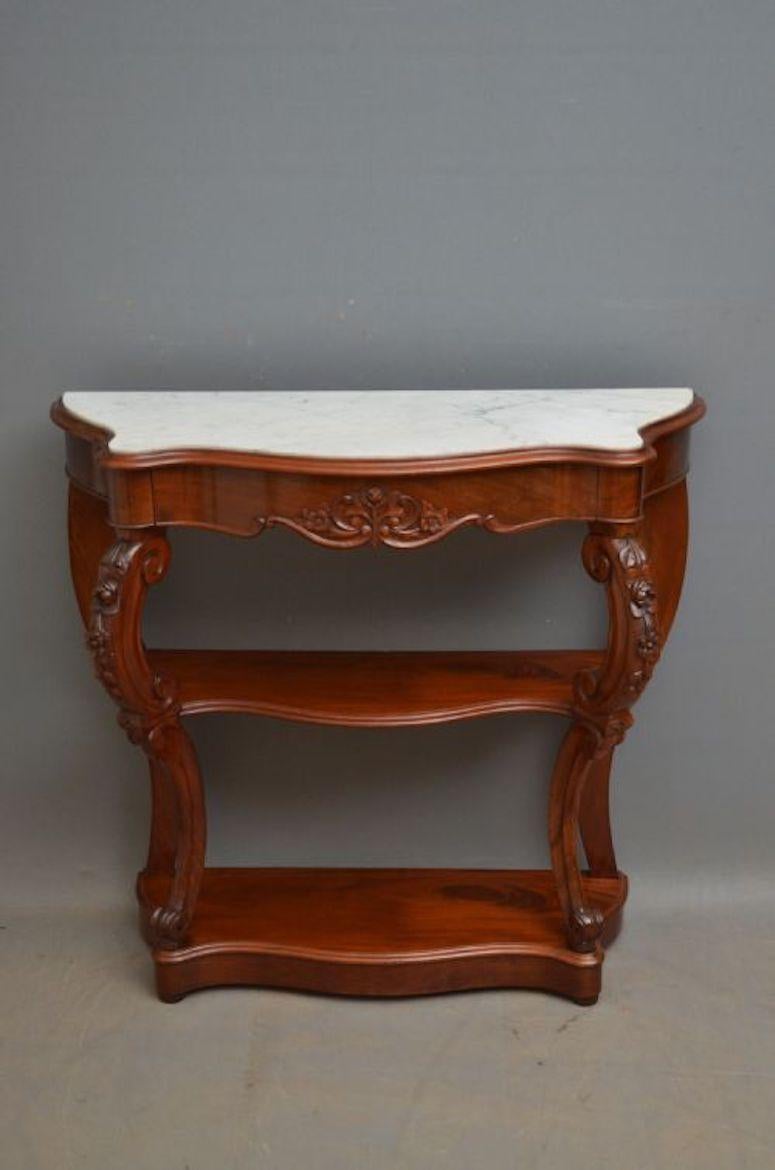 K0296 XIXth century Continental, mahogany hall table of serpentine design, having white veined marble above a carved mahogany lined drawer, standing on carved cabriole legs united by 2 undertiers and terminating in bun feet. This antique hall table