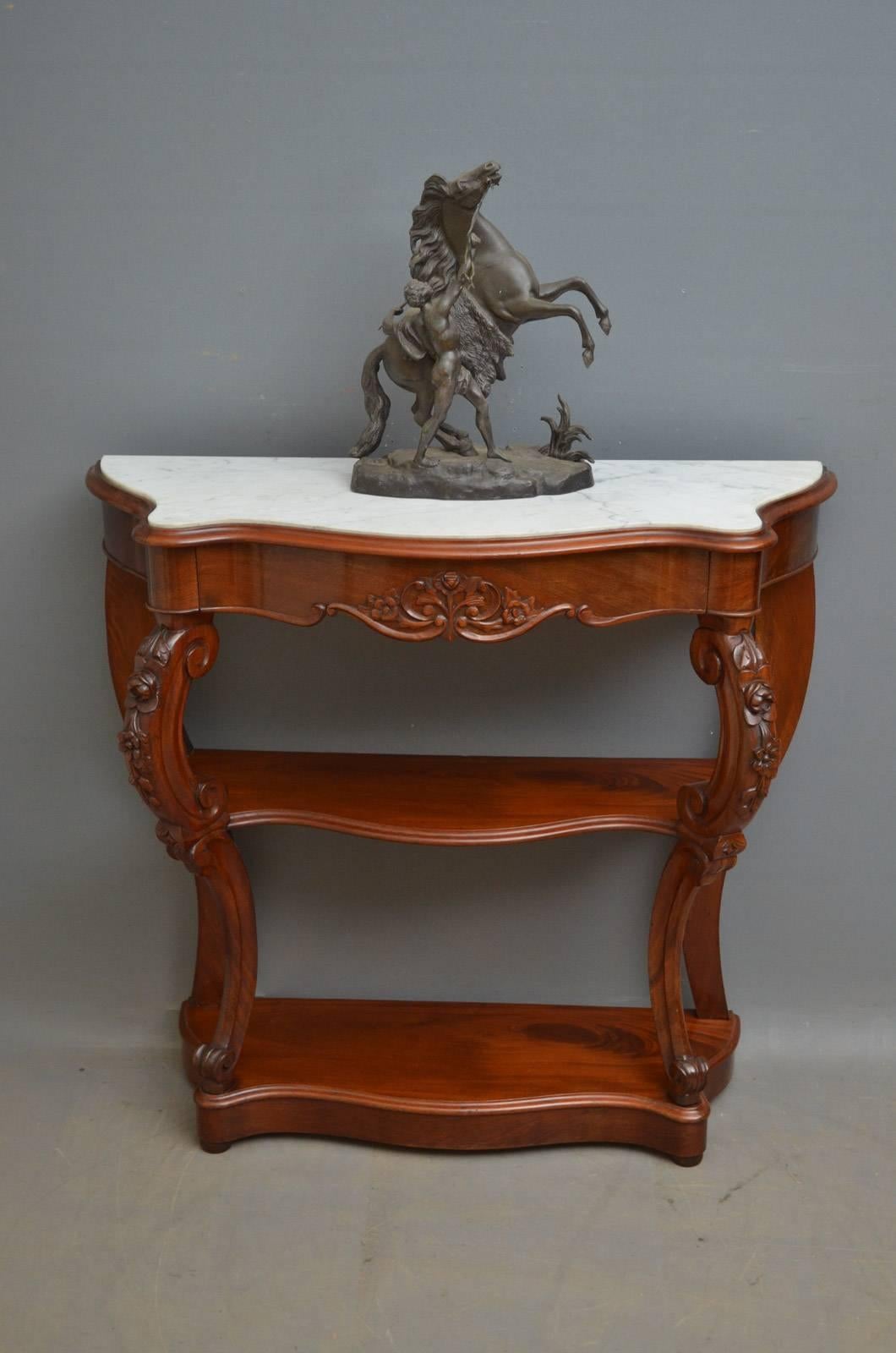 K0296 19th century Continental, mahogany hall table of serpentine design, having white veined marble above a carved mahogany lined drawer, standing on carved cabriole legs united by two undertiers and terminating in bun feet. This antique hall table