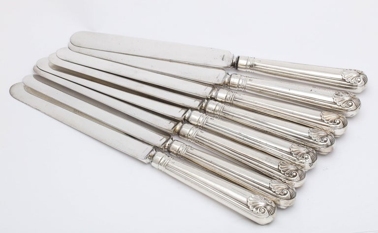 Victorian Period set of 8 sterling silver-handled dinner knives (having silver-plated blades), London, year-hallmarked for 1865, George William Adams - maker. Sterling silver handles are decorated with an etched armorial of a raised arm holding a